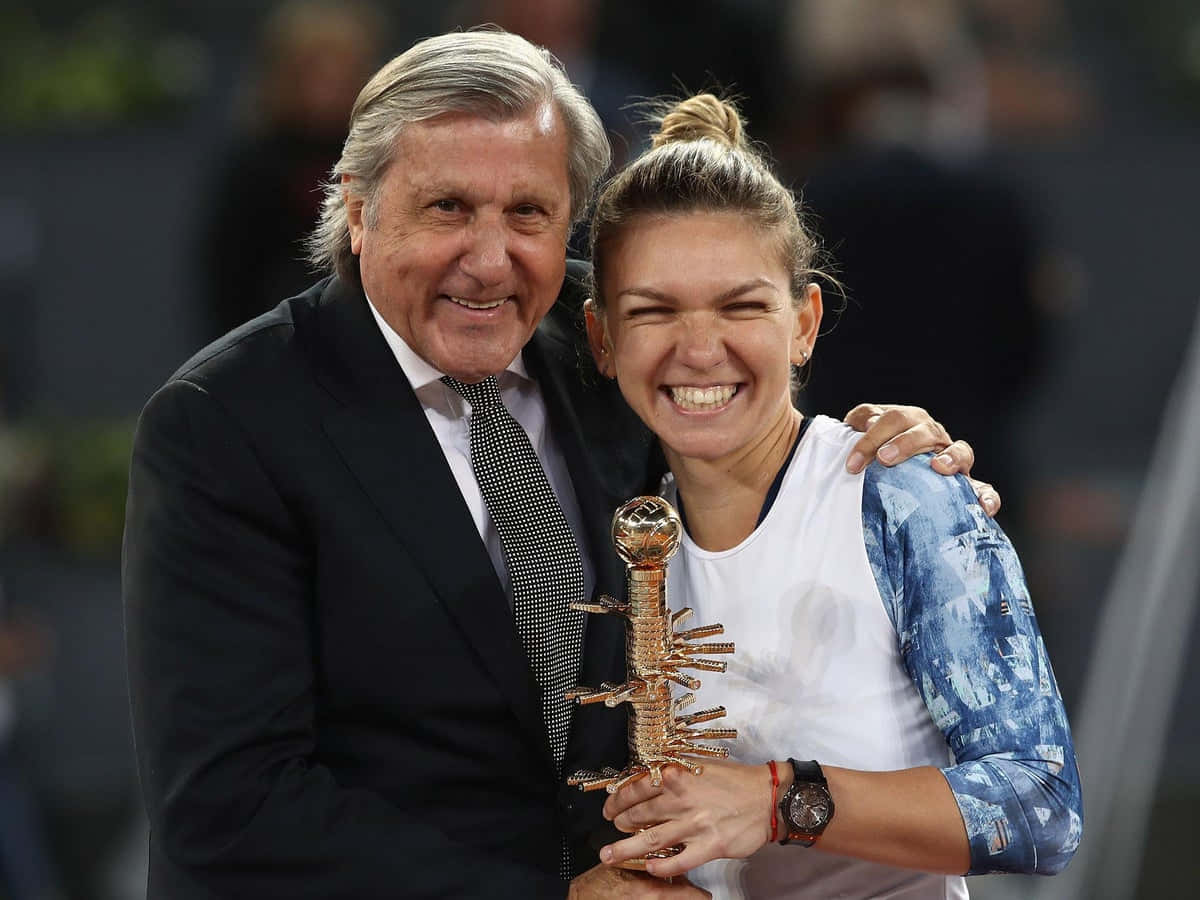 Ilie Năstase Cheering For Simona Halep On The Tennis Court Background