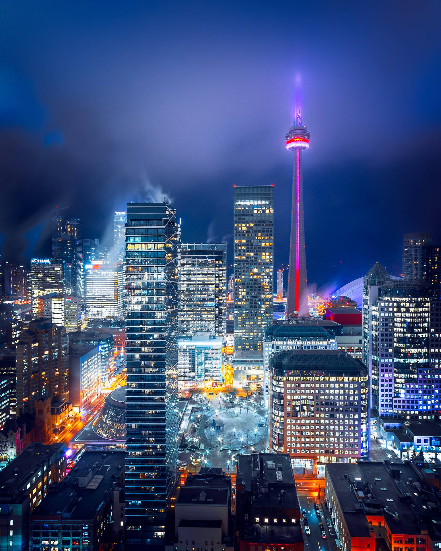 Illuminated Cityscape Against The Night Sky