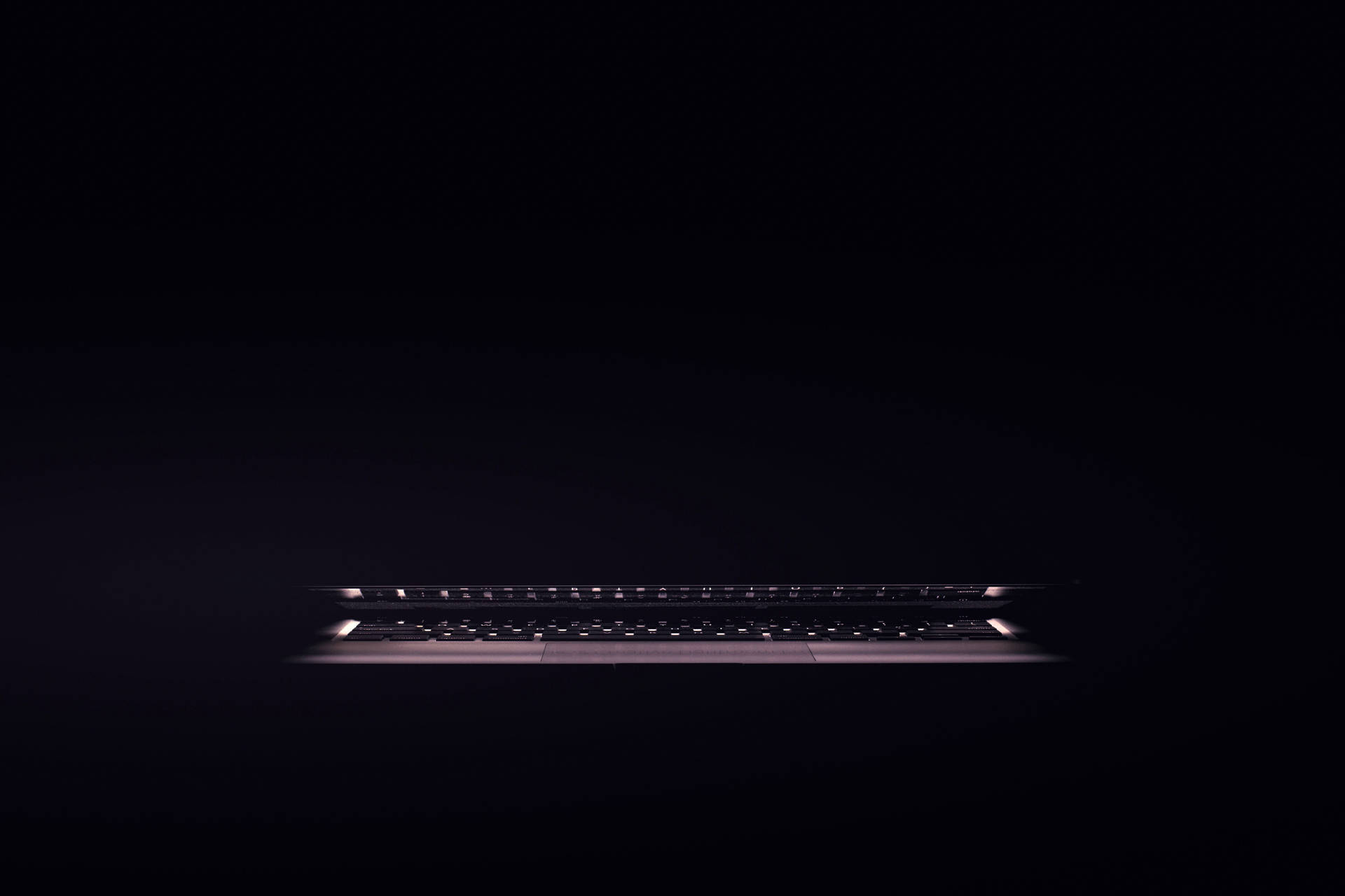 Illuminated Dark Laptop Keyboard Background