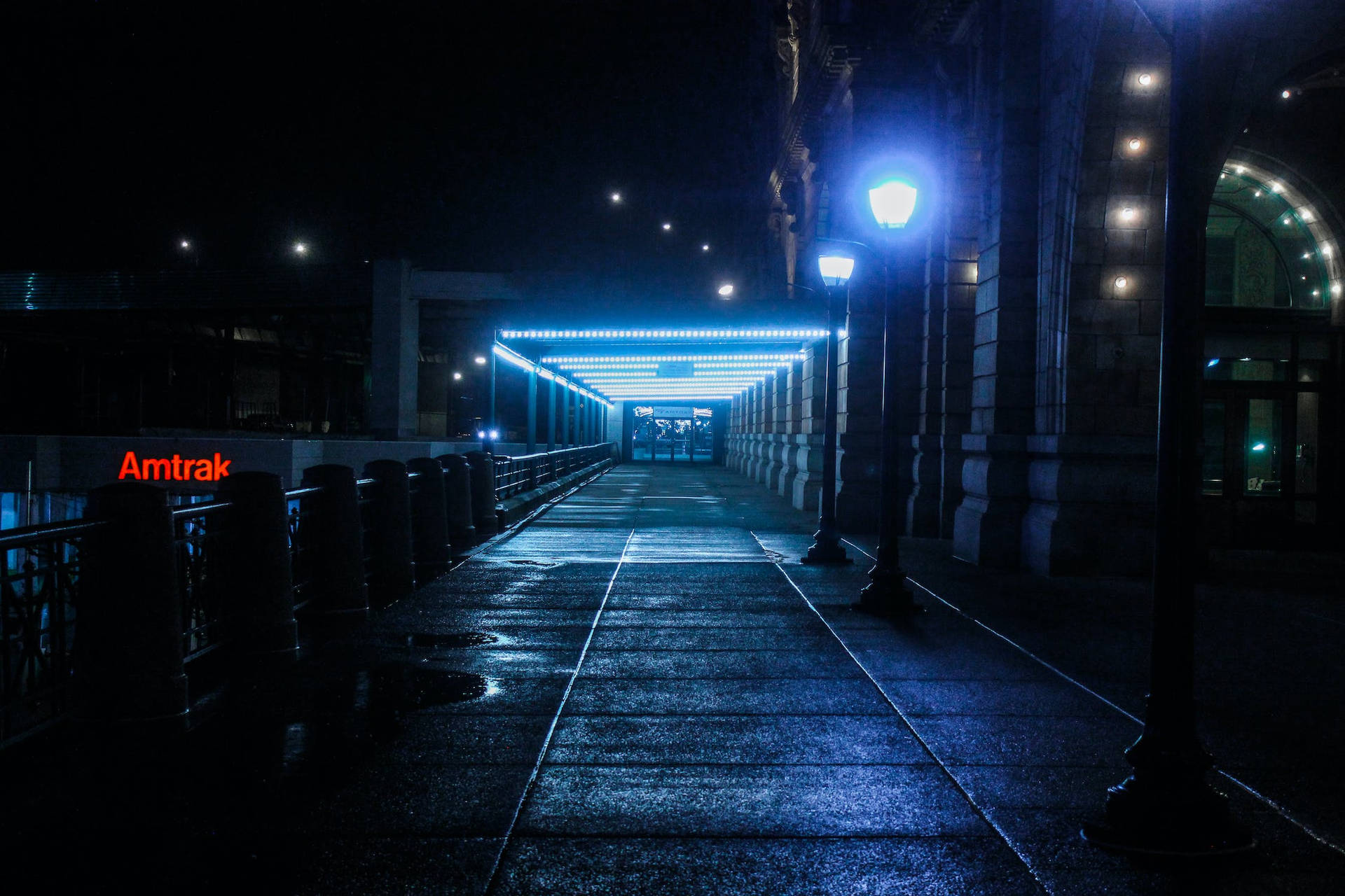 Illuminated Lamp Against The Vibrant Night City Background