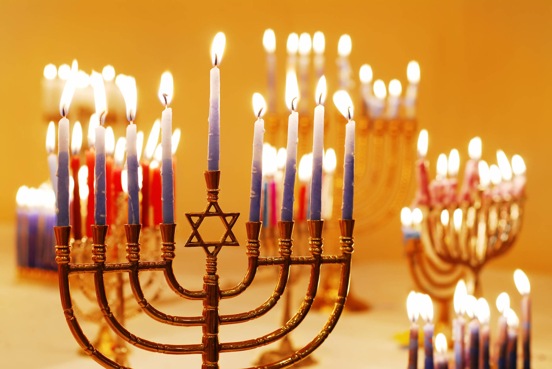 Illuminated Menorah Symbolizing Hanukkah Celebration Background