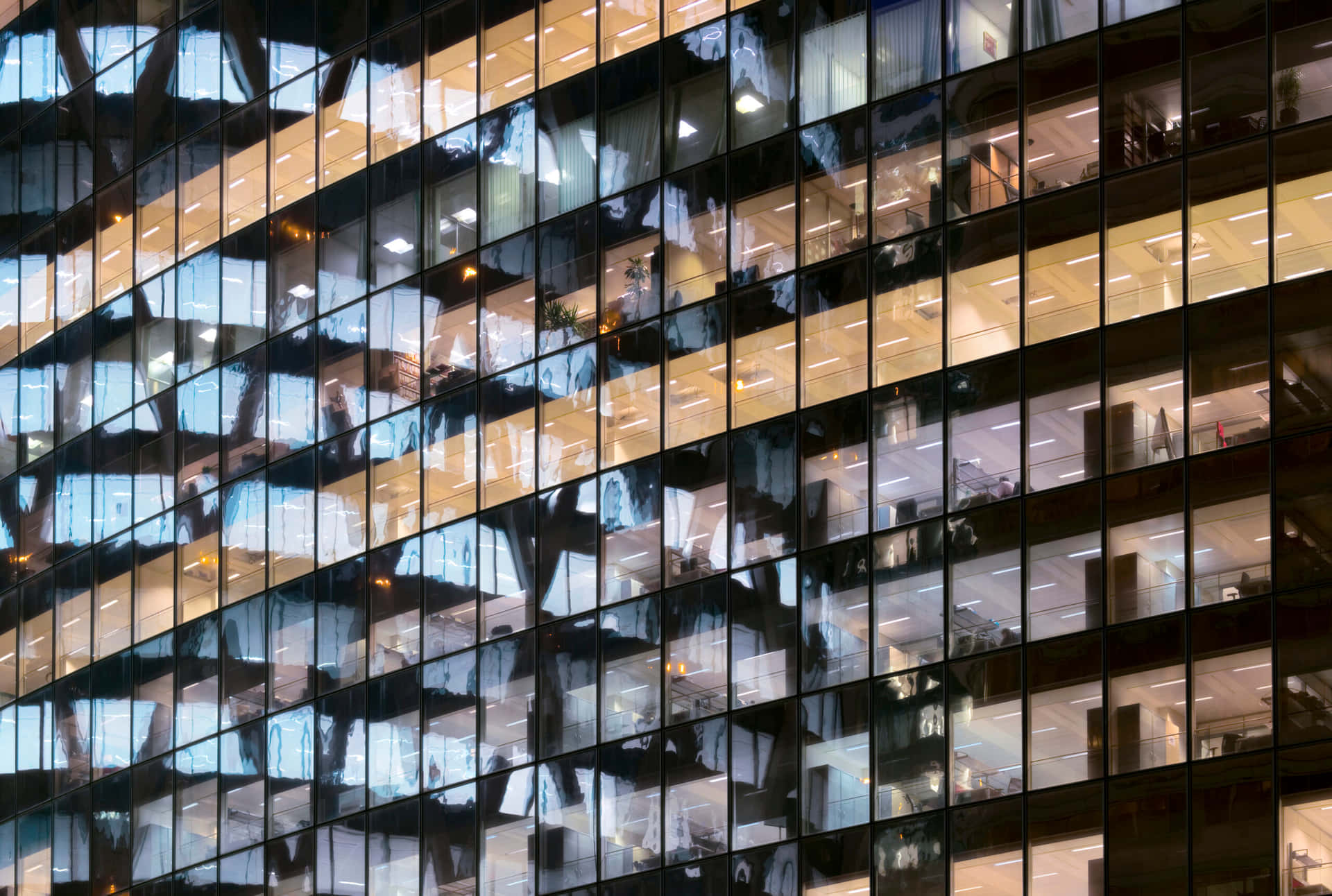 Illuminated_ Office_ Building_at_ Night Background