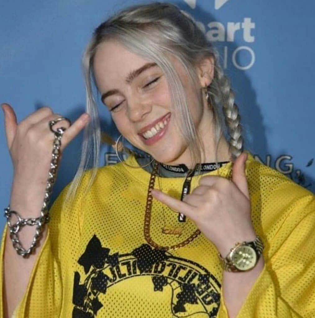 Image Billie Eilish Showing Her Signature Toothy Smile Background