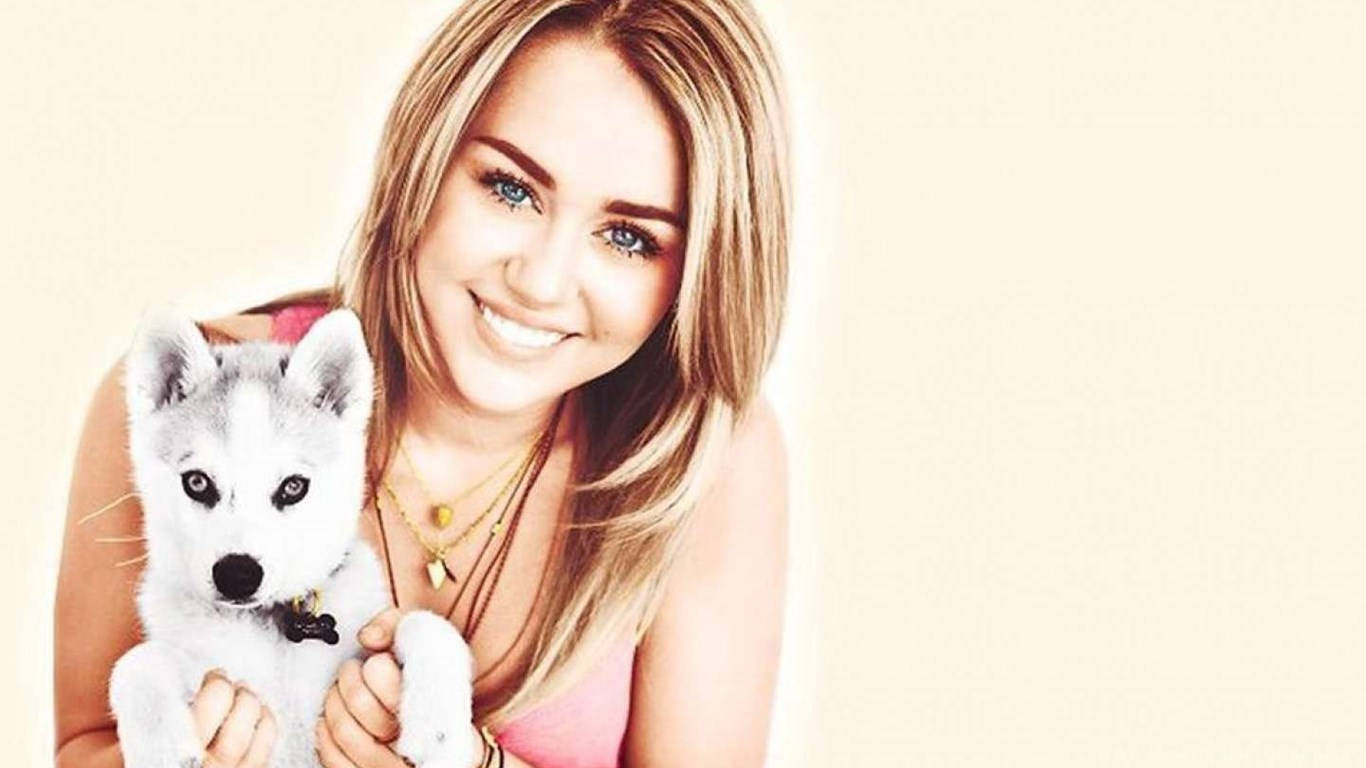 Image Delightful Miley Cyrus Enjoying Time With Her Puppy Background