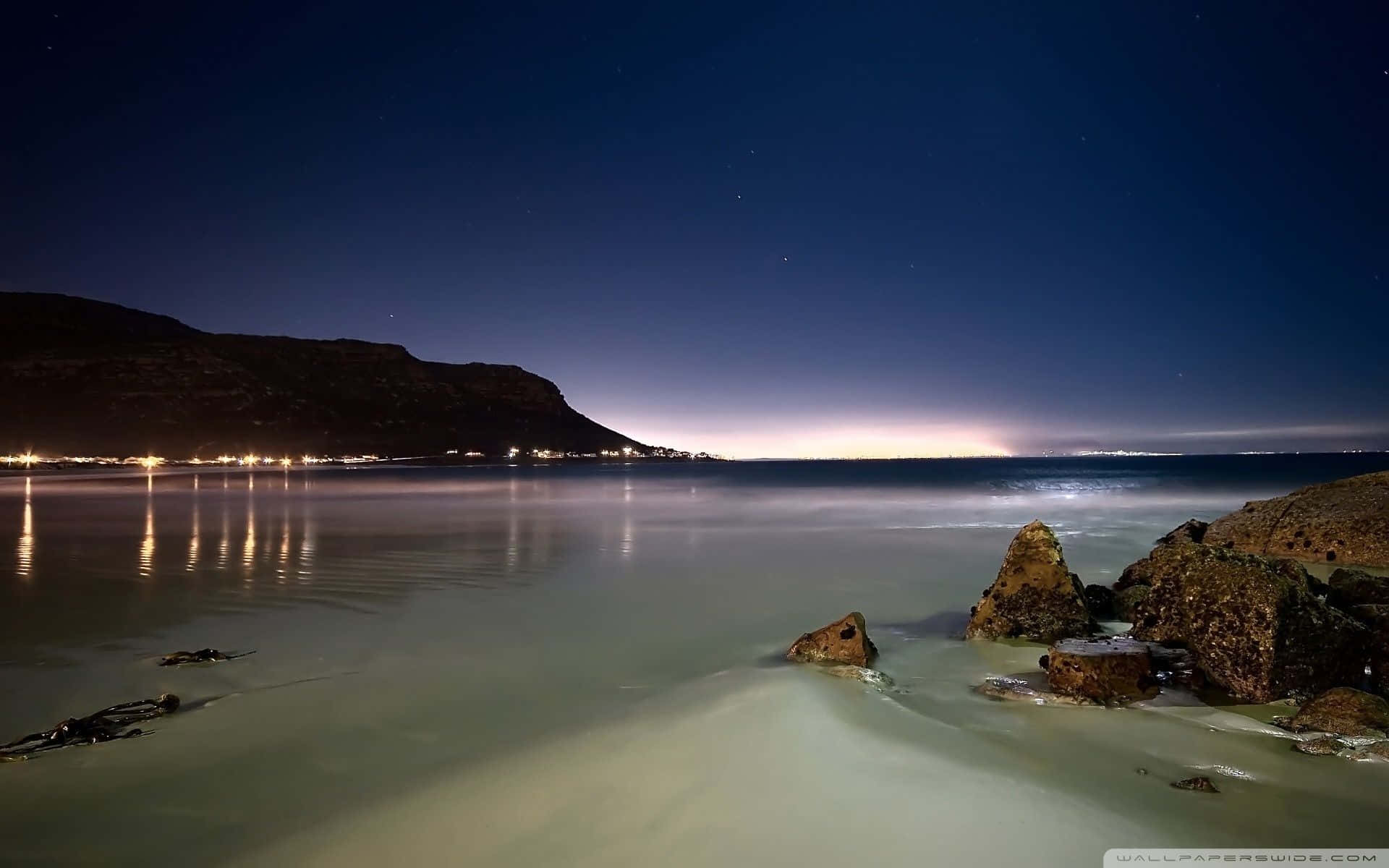 Image Masses Of Beachgoers Taking In A Beautiful Beach View Background