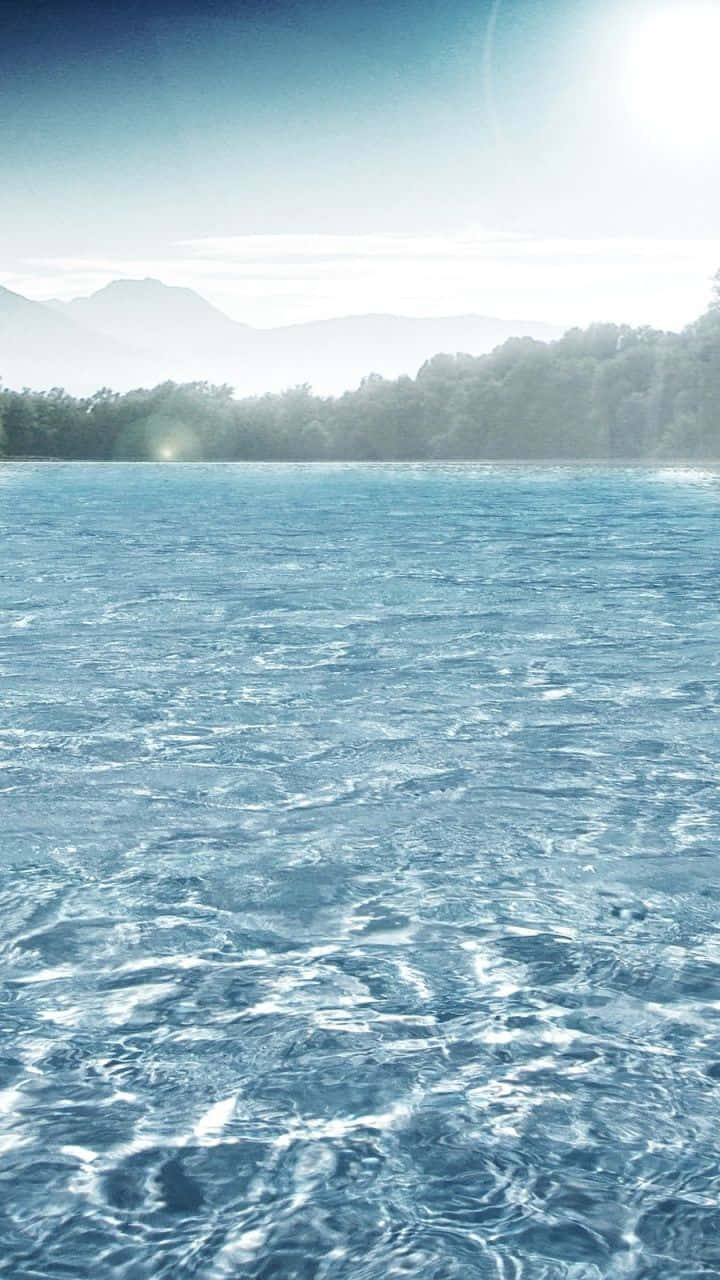 Immerse Yourself In The Perfect Blend Of Nature And Technology With This Water Iphone Wallpaper. Background