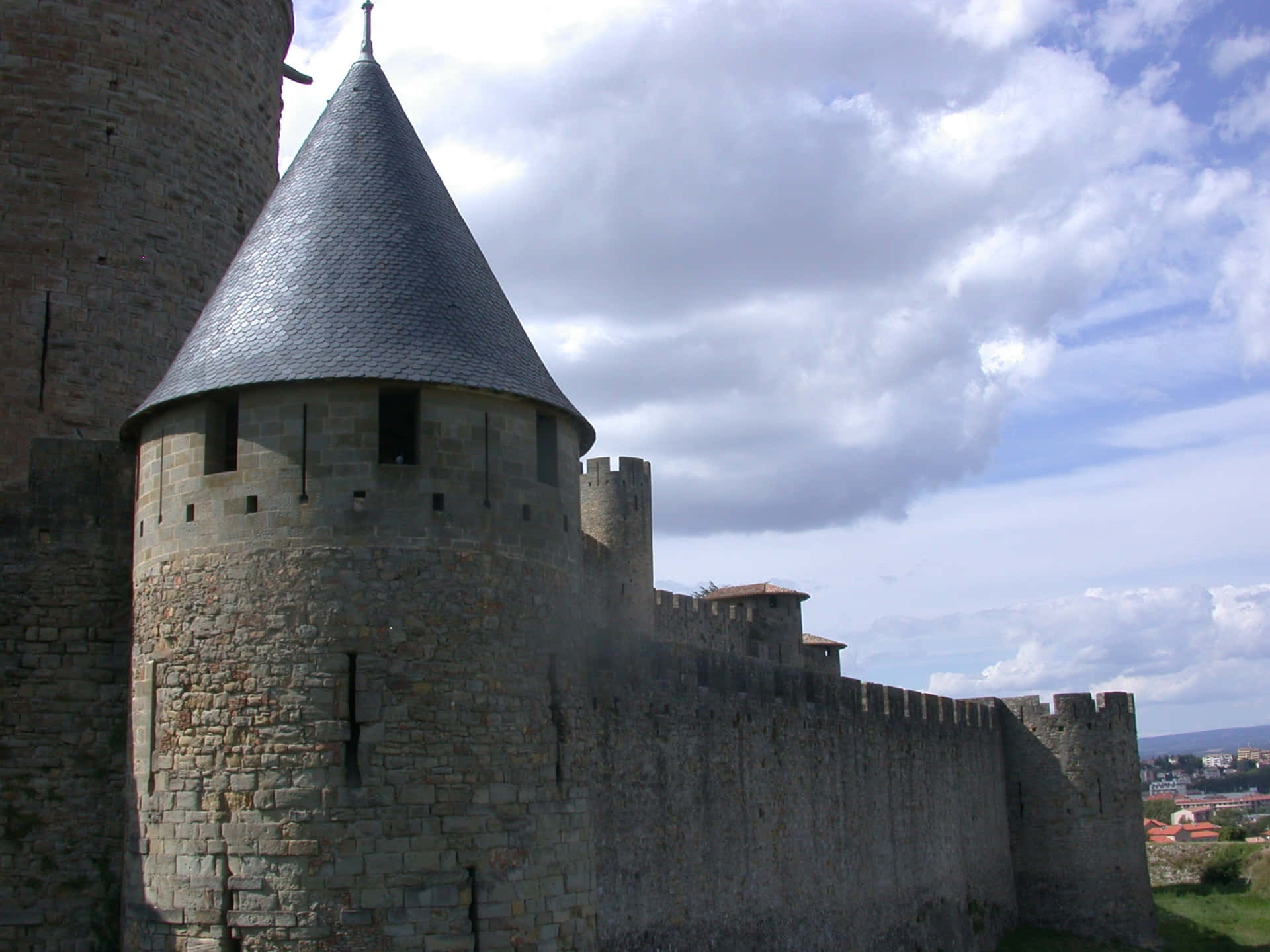 Imposing Ancient Fortress Walls Of Cité De Carcassonne Background
