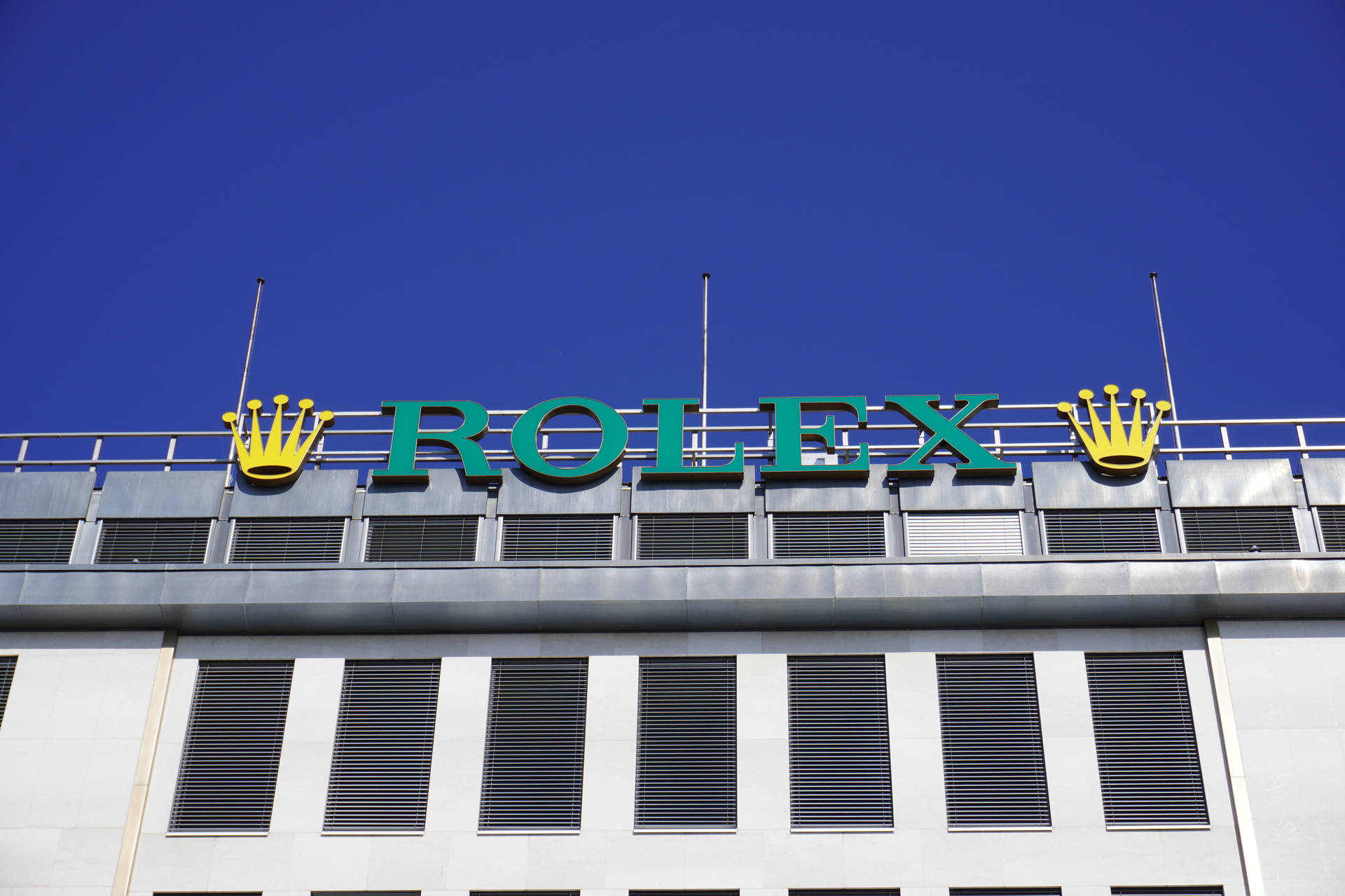 Impressive Rolex Logo On Building Facade Background
