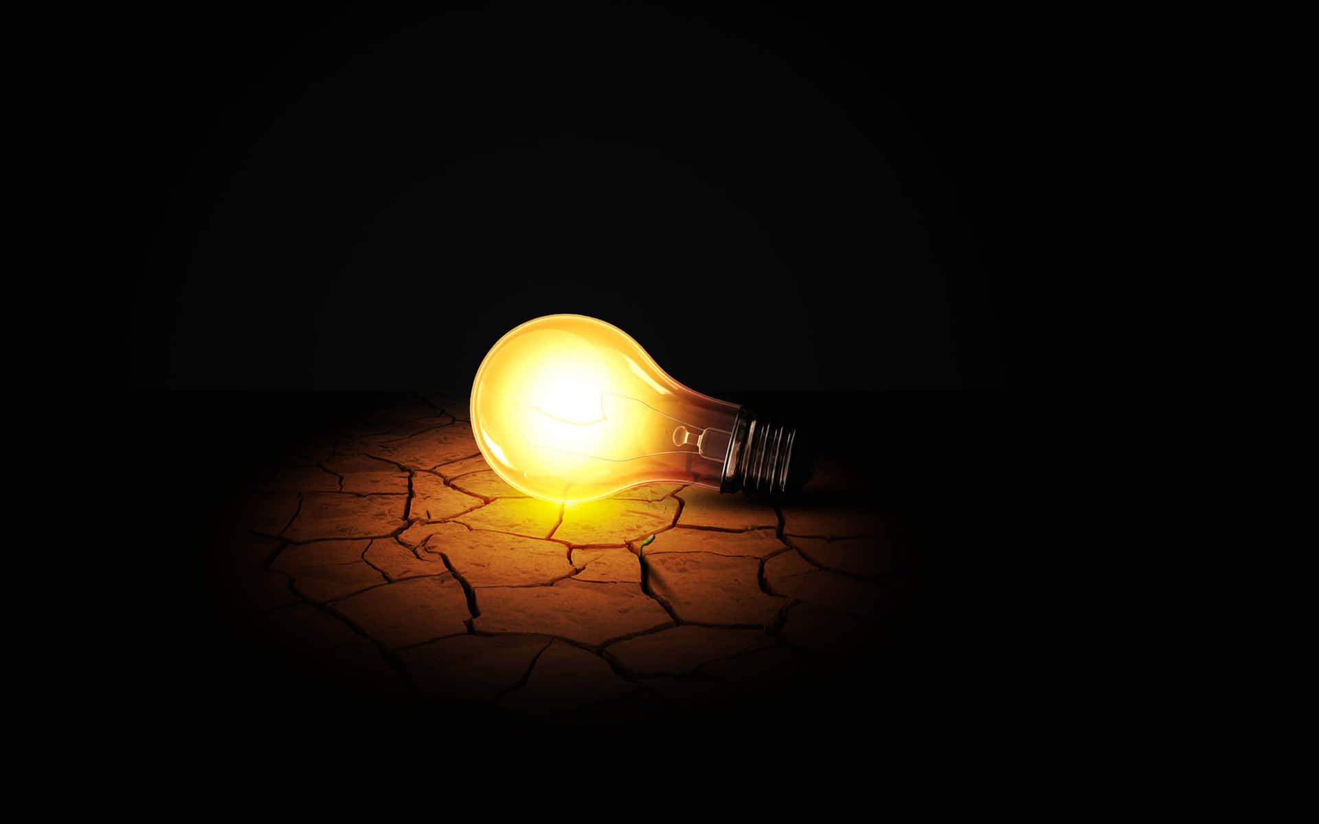 Incandescent Bulb On Cracked Ground Background