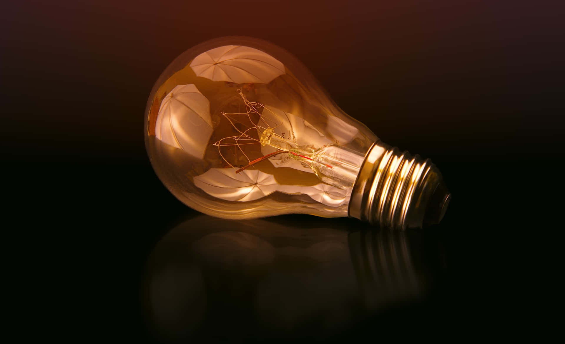 Incandescent Bulb On Maroon Background Background