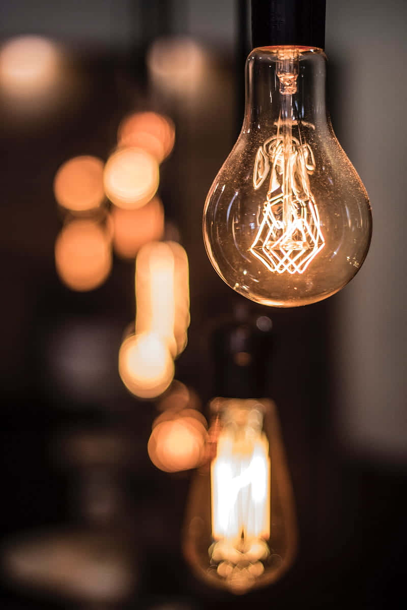Incandescent Bulb With Abstract Filament Background