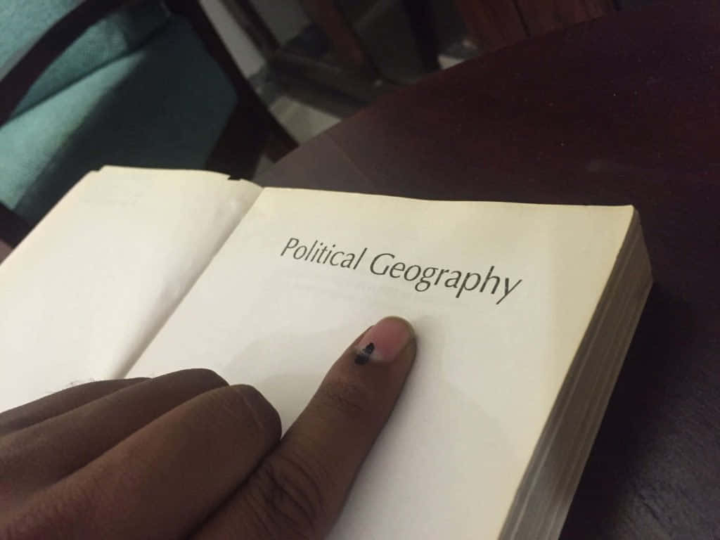 Indelible Ink On Hand While Scanning A Book Background