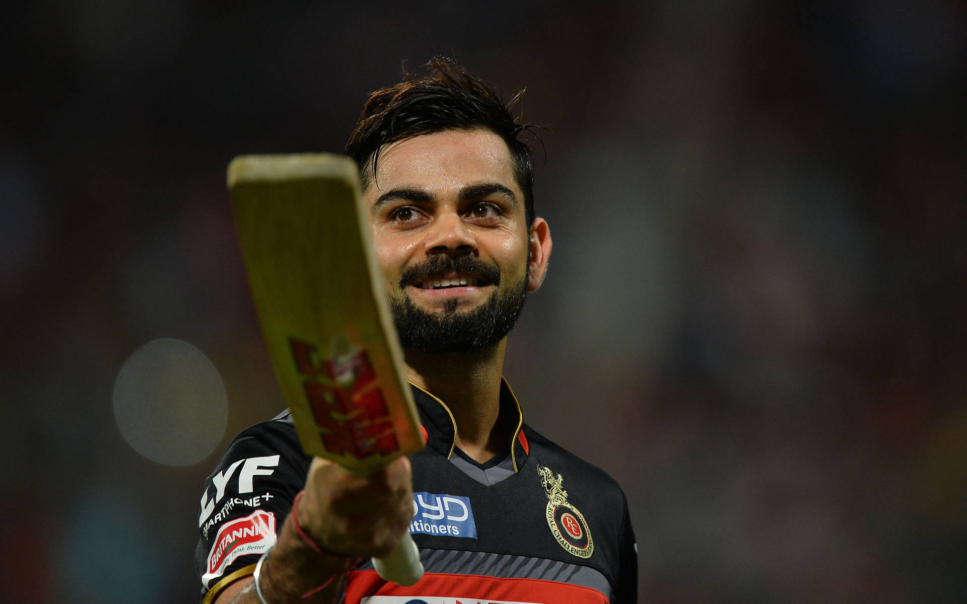 Indian Cricket Team Player Kohli In Black Uniform Background