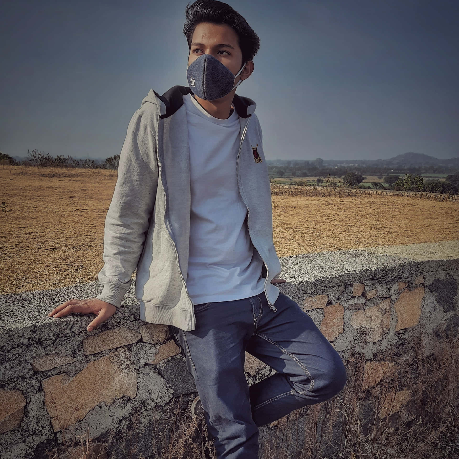 Indian Guy In White Jacket And Gray Pants Background