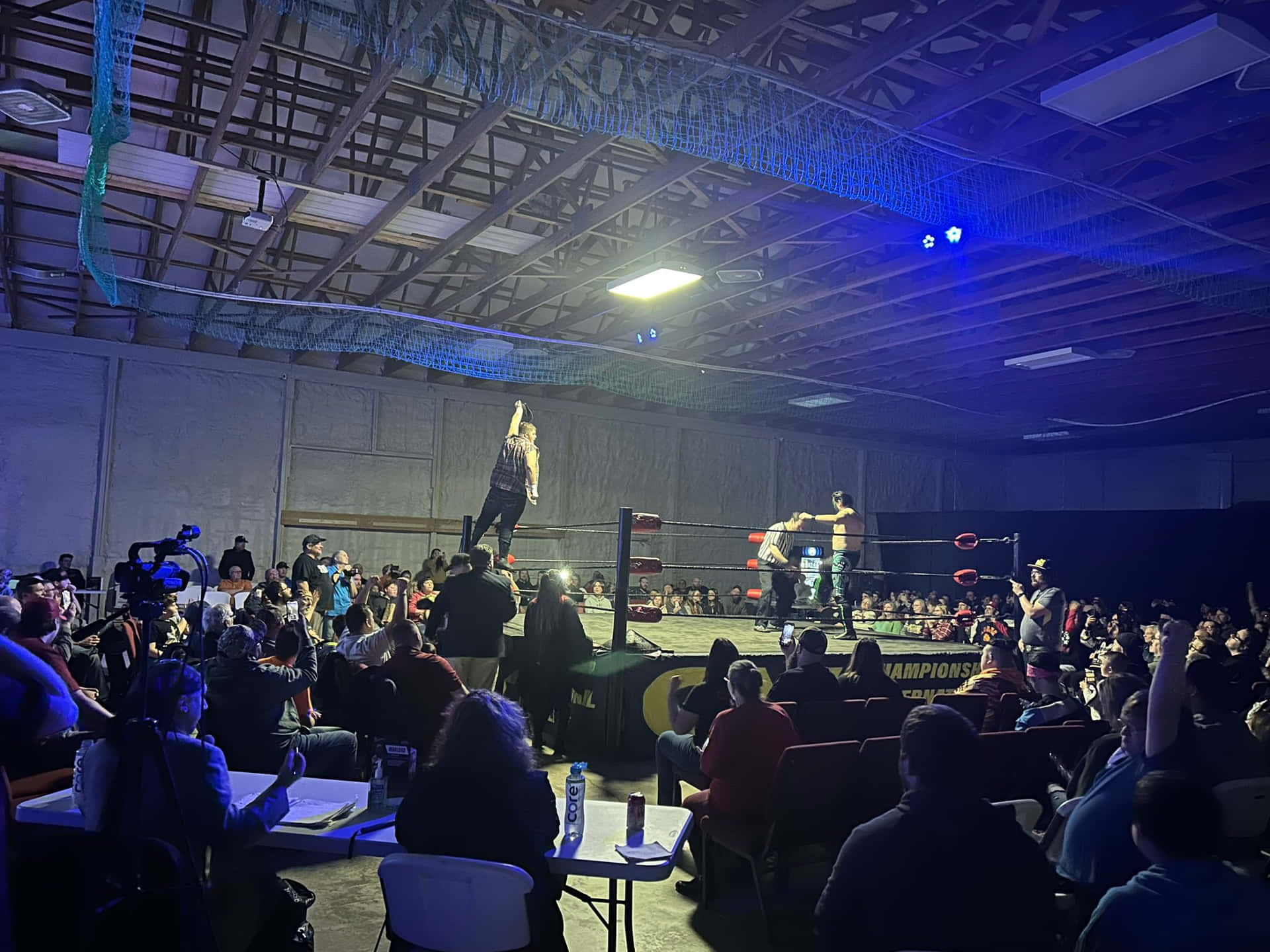 Indoor Wrestling Match Excitement Background