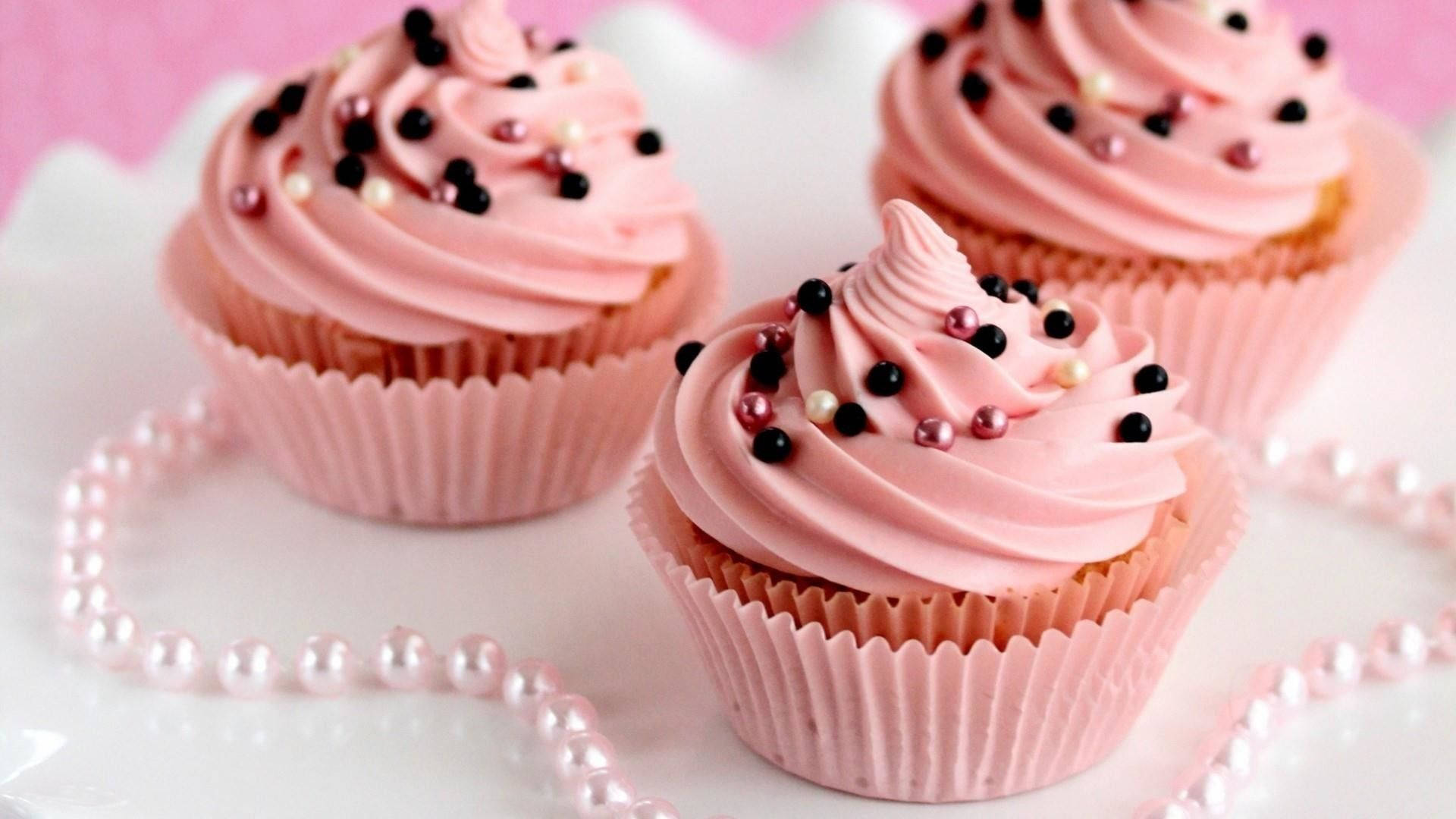 Indulgent Pink Cupcake With Sprinkles Background