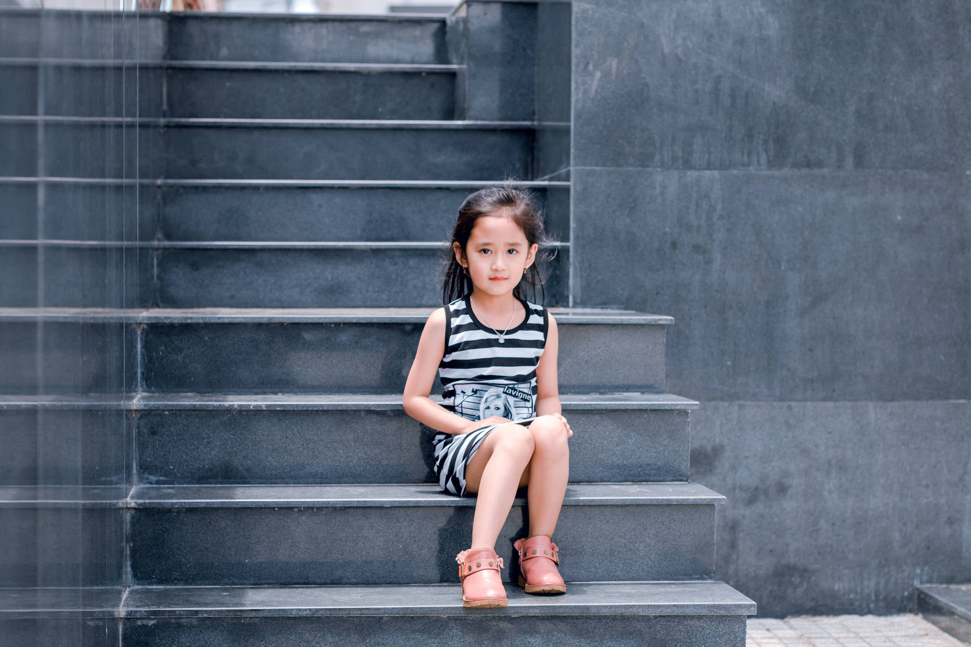 Innocent Glance - Adorable Girl On Grey Stairway