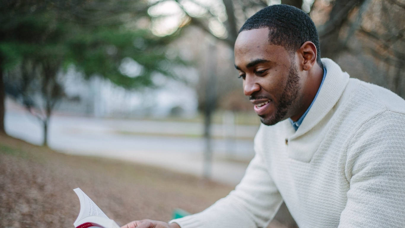 Intelligent Handsome Man Engrossed In Reading Background