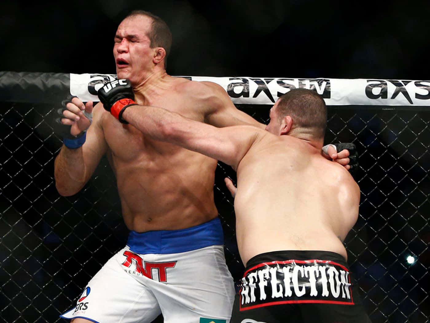 Intense Action In The Octagon: Junior Dos Santos Vs Cain Velasquez Trilogy Fight Background