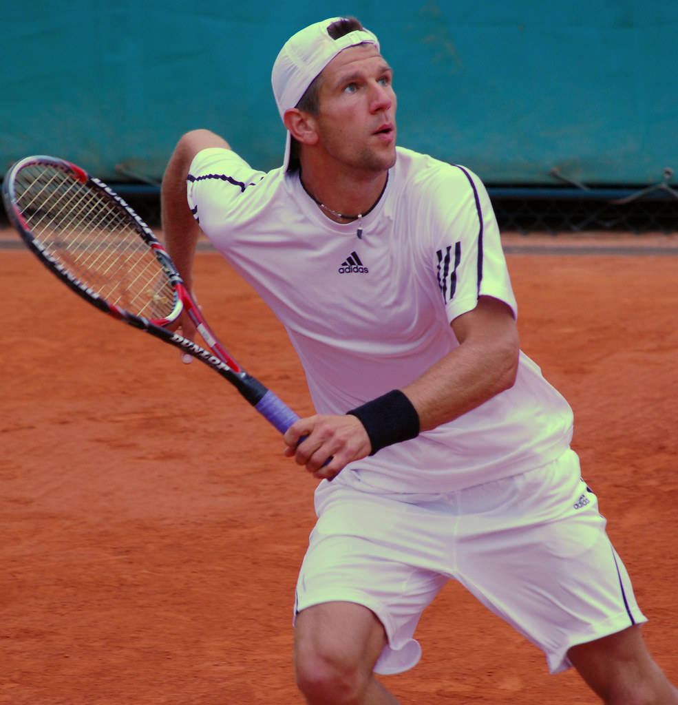 Intense Action: Jurgen Melzer In Pursuit Of The Tennis Ball Background