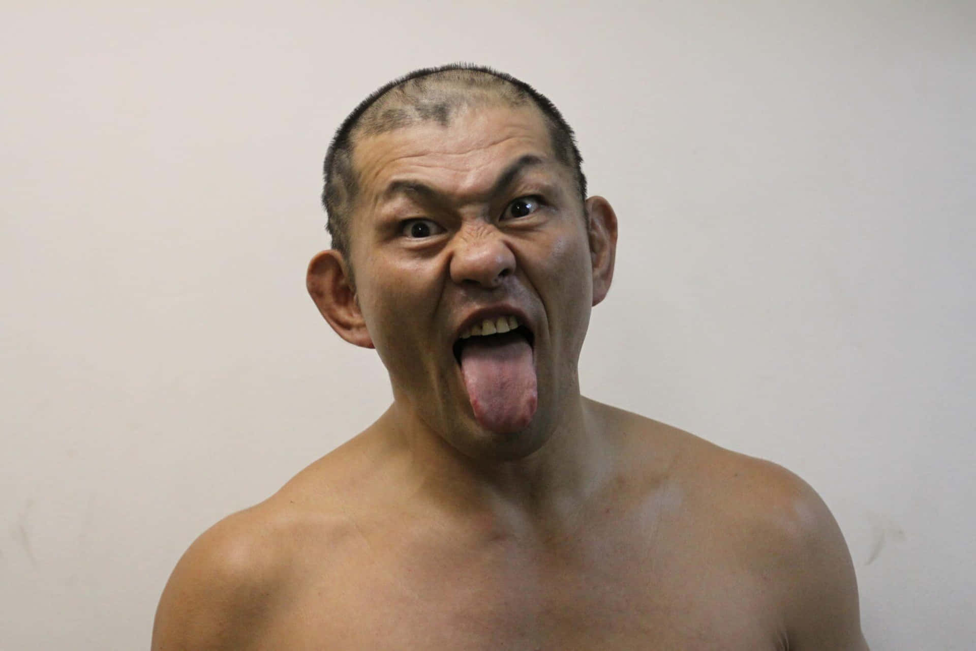 Intense Action Shot Of Wrestler Minoru Suzuki Background