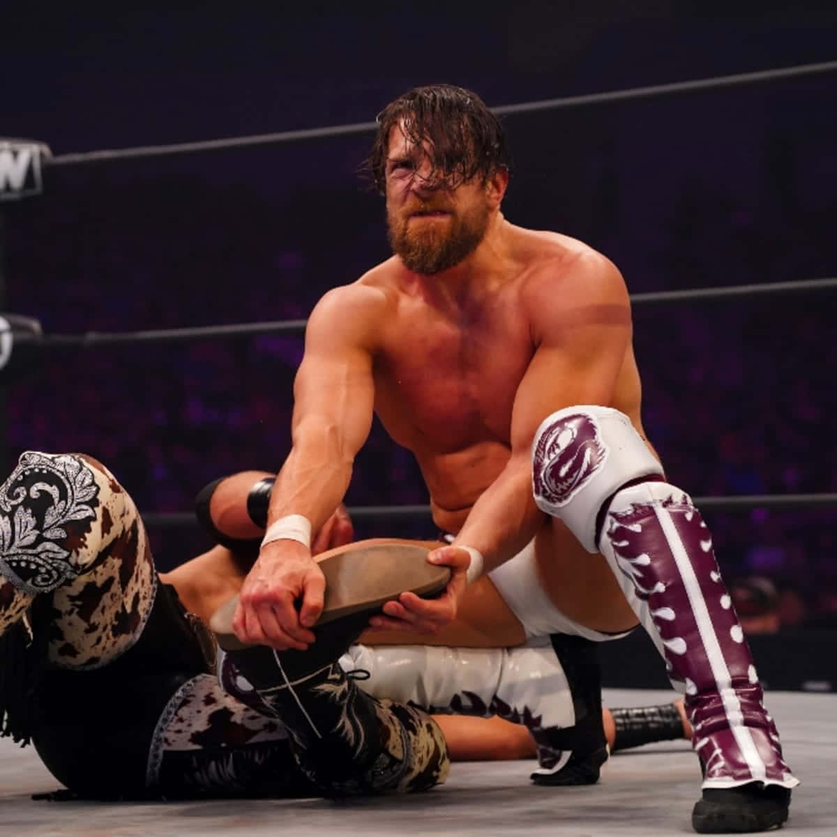 Intense Action With Bryan Danielson In A Wrestling Match Background