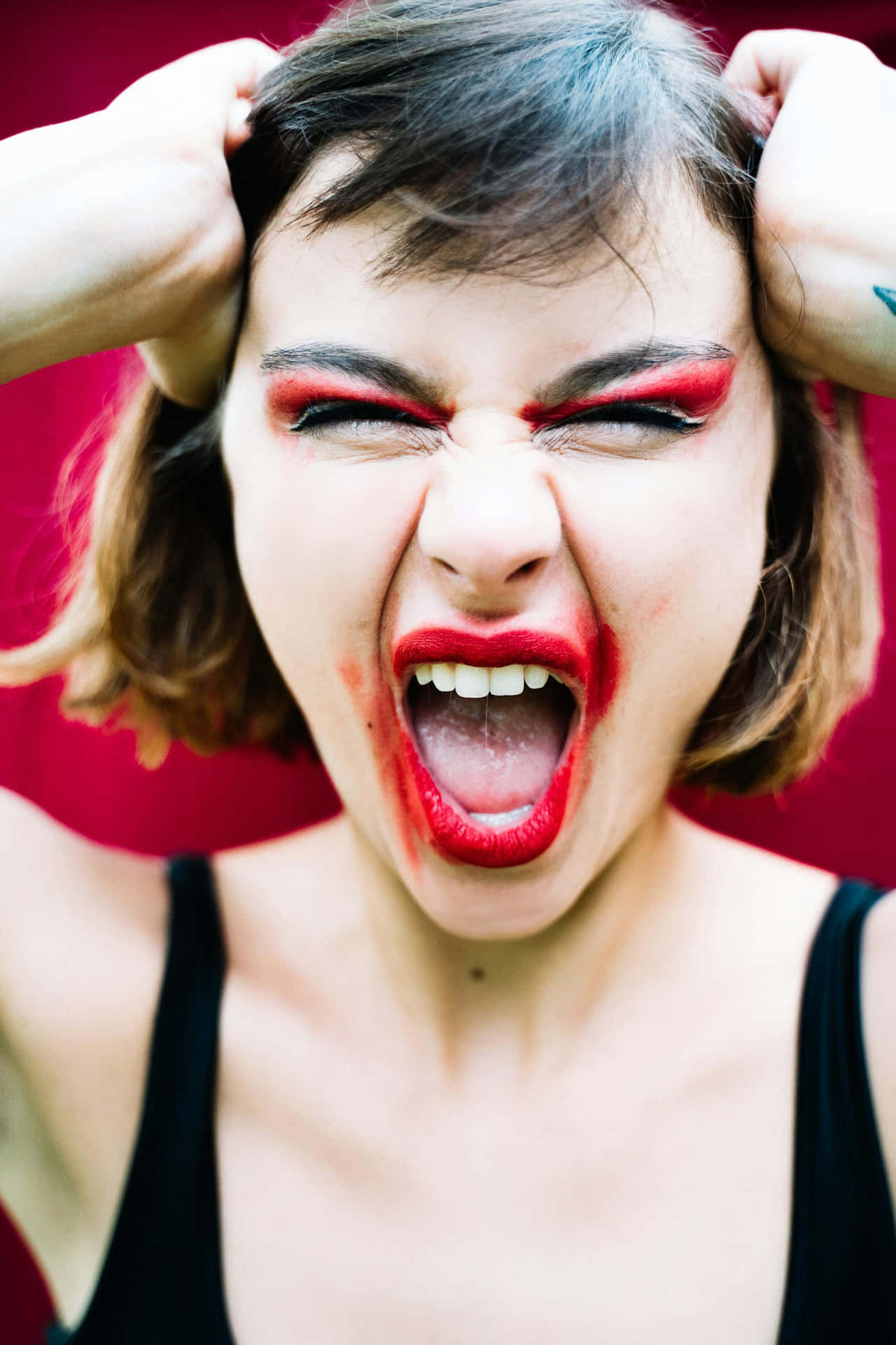 Intense Expression Against Red Background Background