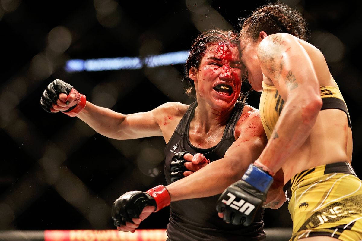 Intense Face-off Between Julianna Peña And Amanda Nunes Background