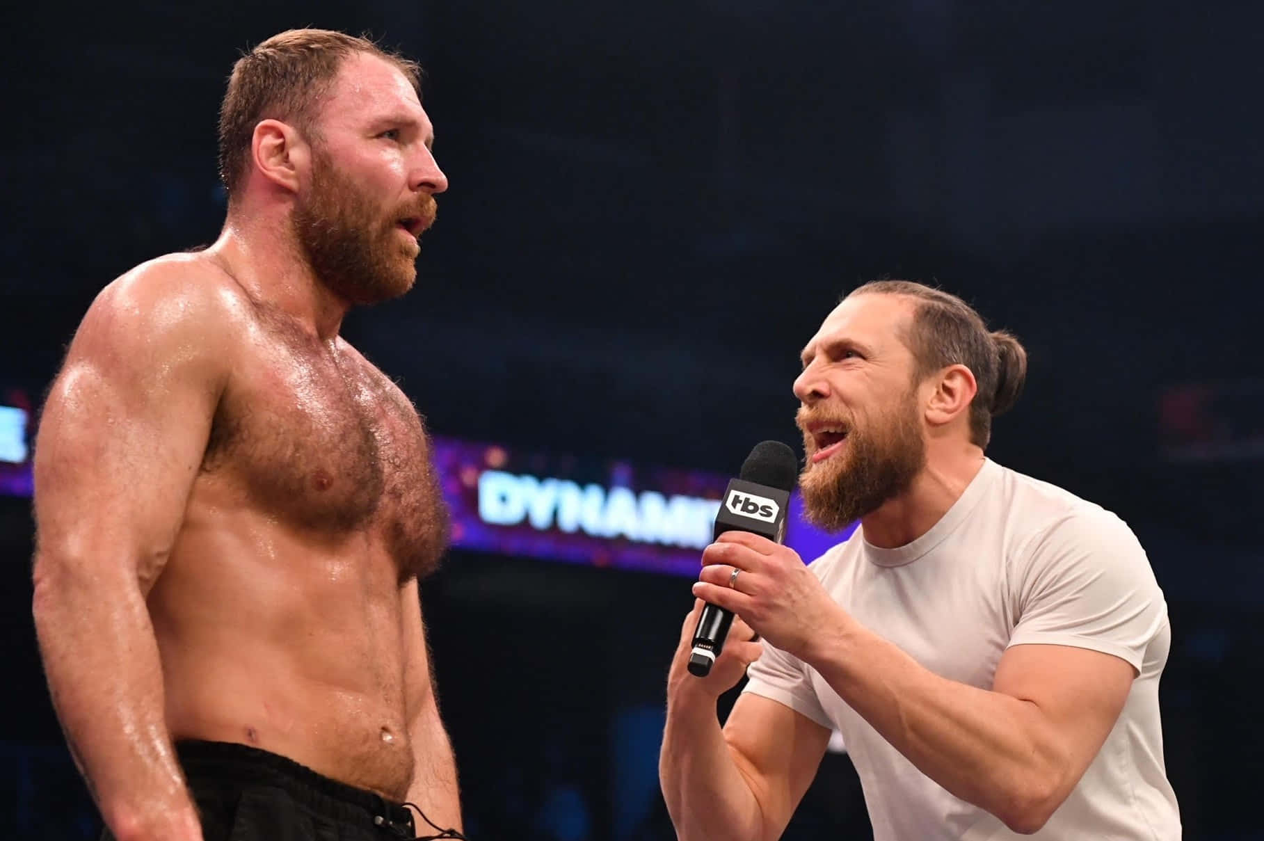 Intense Face-off: Jon Moxley And Bryan Danielson In The Ring Background