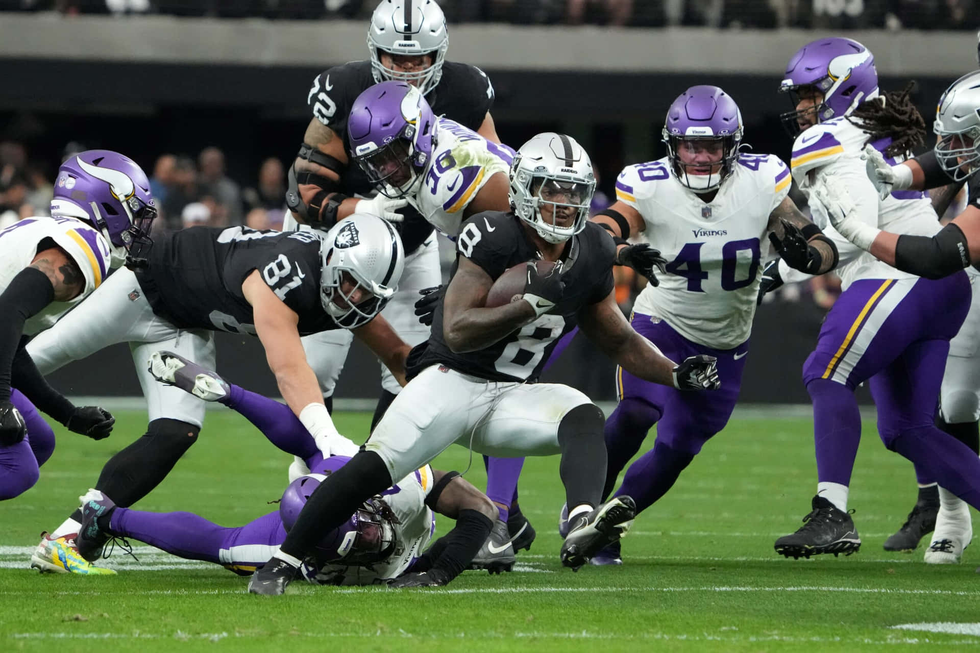 Intense Football Action Raidersvs Vikings Background