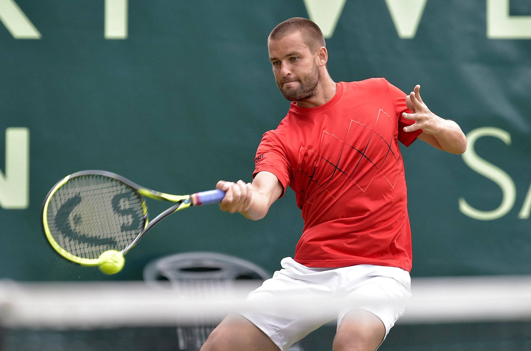 Intense Game - Mikhail Youzhny In Action On The Court Background