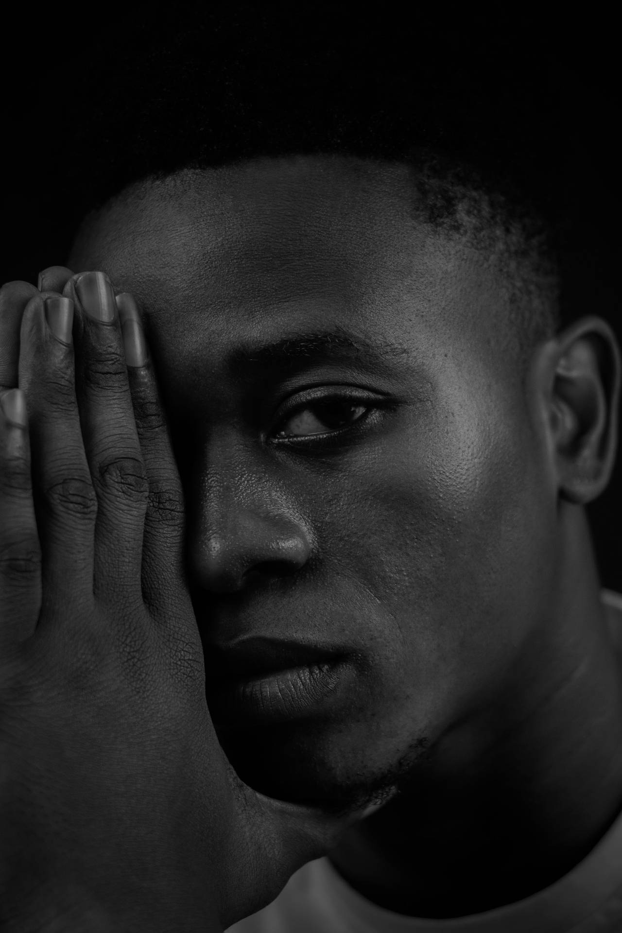 Intense Gaze: A Black And White Portrait Of A Man Background