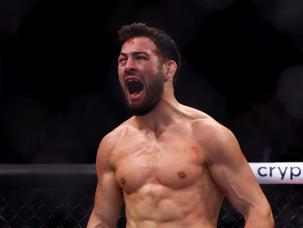 Intense Moment Of Victory: Bloodied Nassourdine Imavov Roaring Post Fight Background