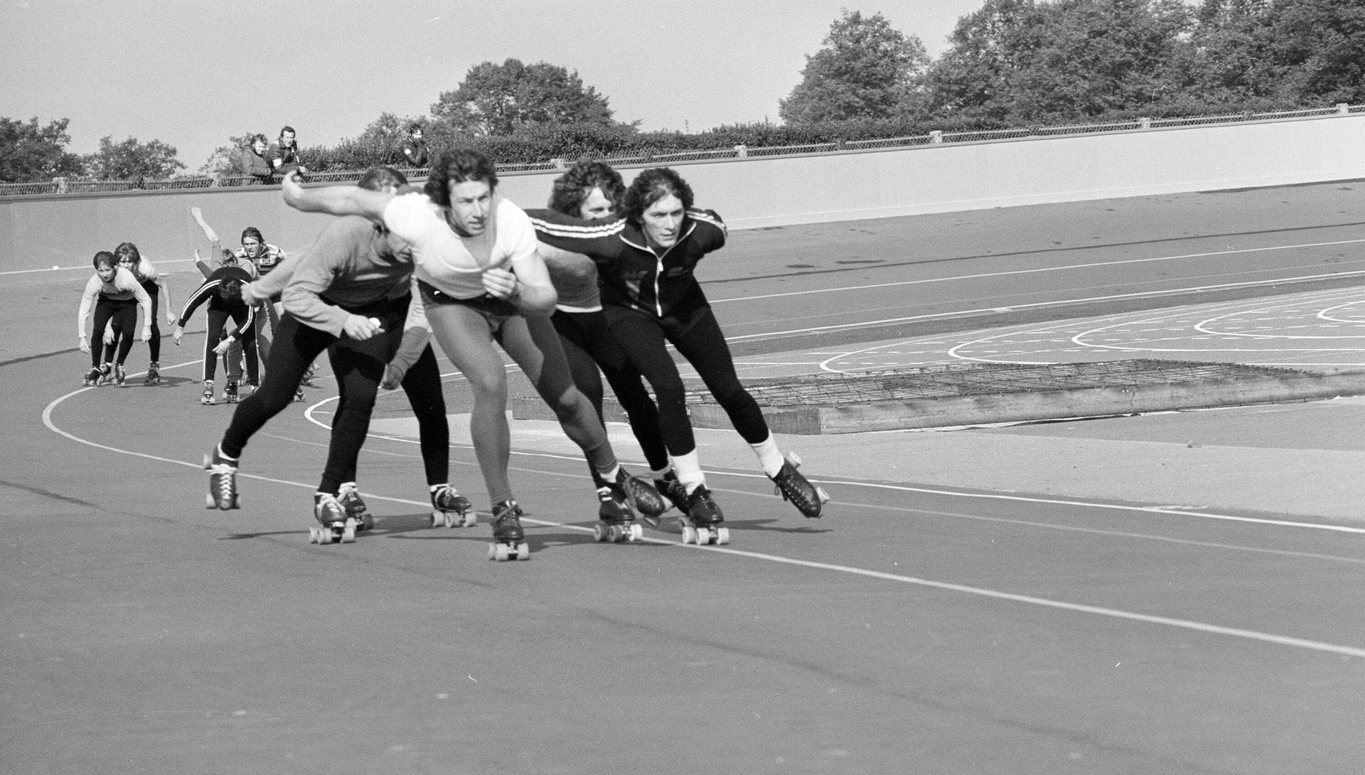 Intense Speed Skating Competition In Full Swing Background