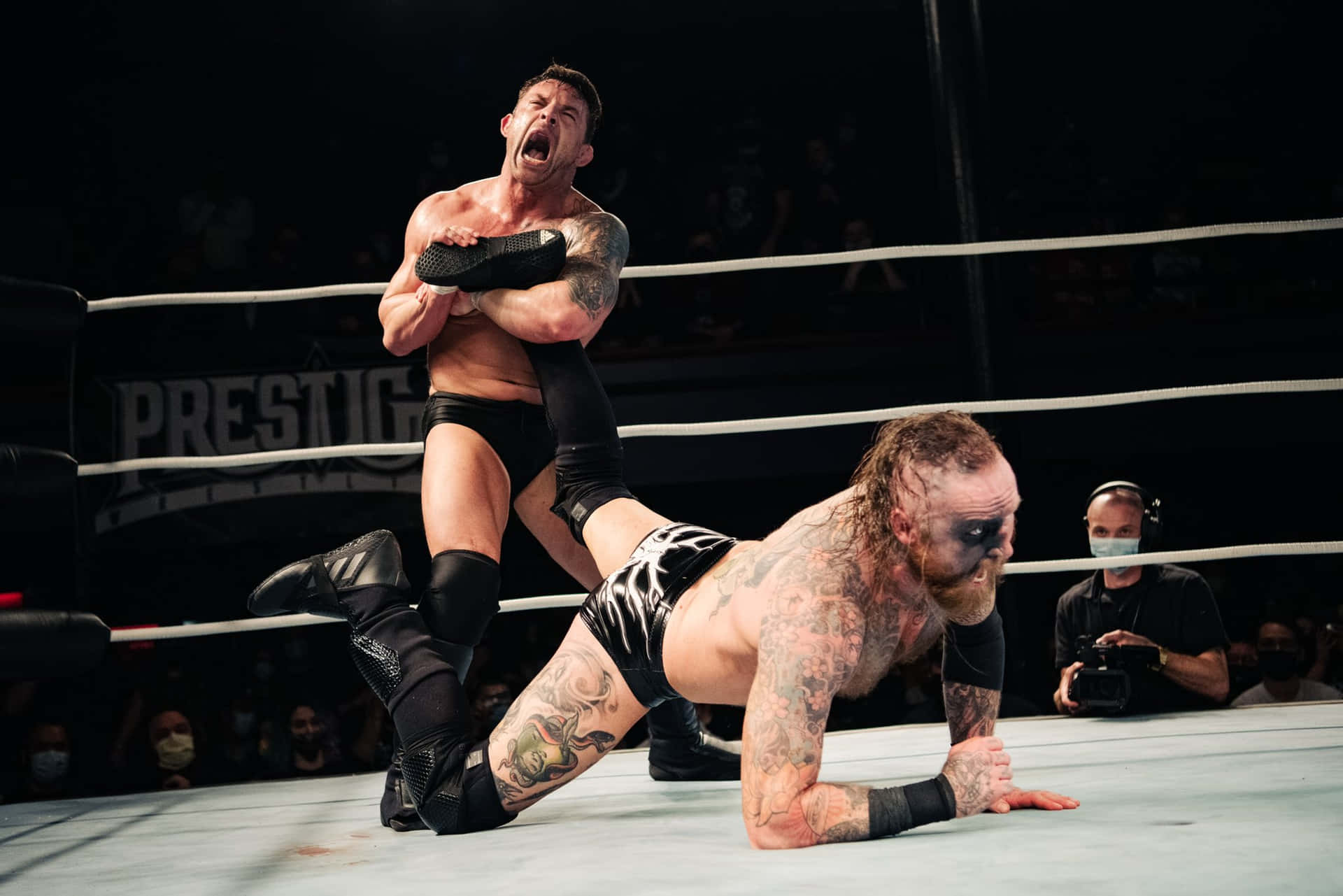 Intense Wrestling Match Between Davey Richards And Malakai Black Background
