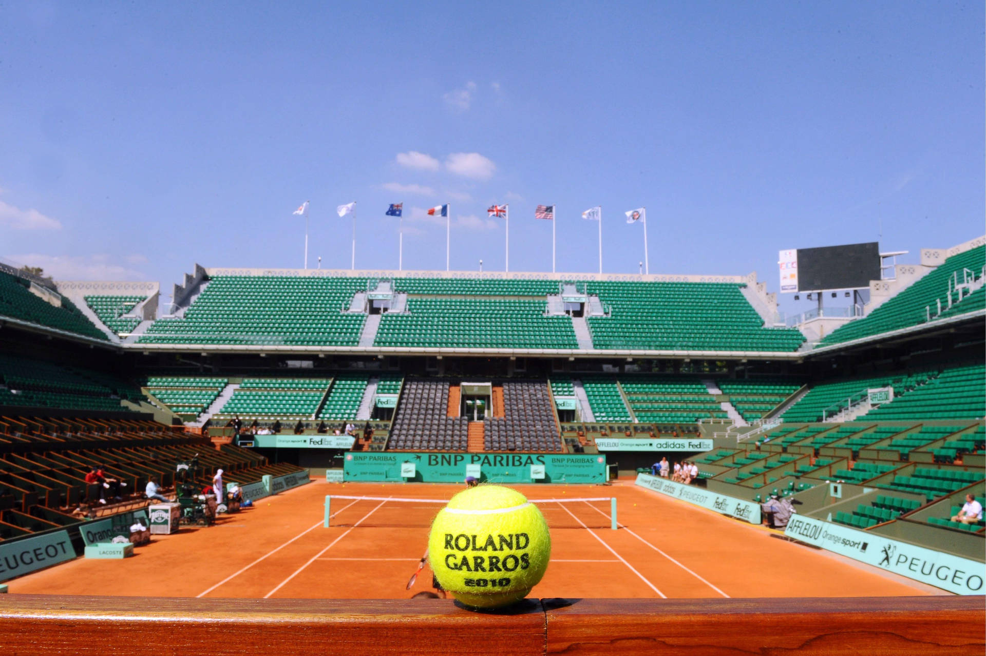 Intensity On Clay - A Close-up Of A Tennis Ball On French Open Court Background