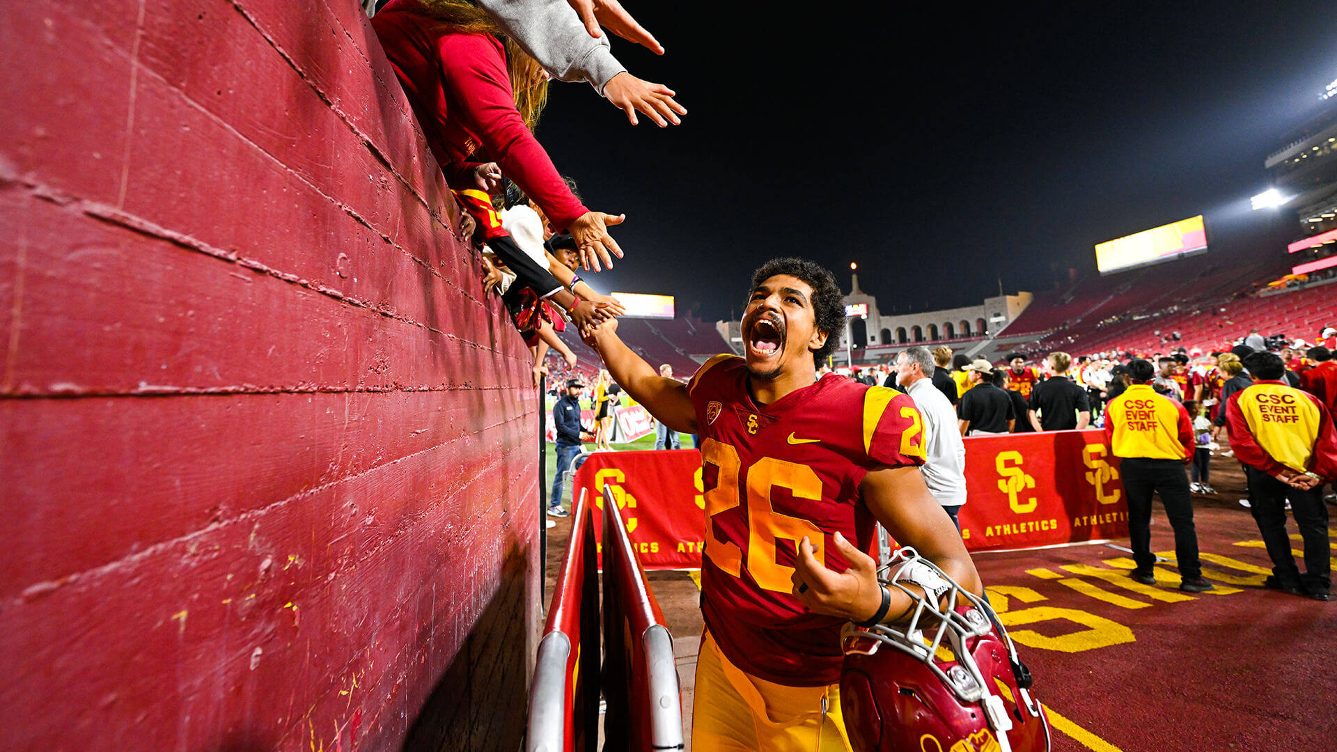 Intensity On Field - Usc Football Player In Action Background