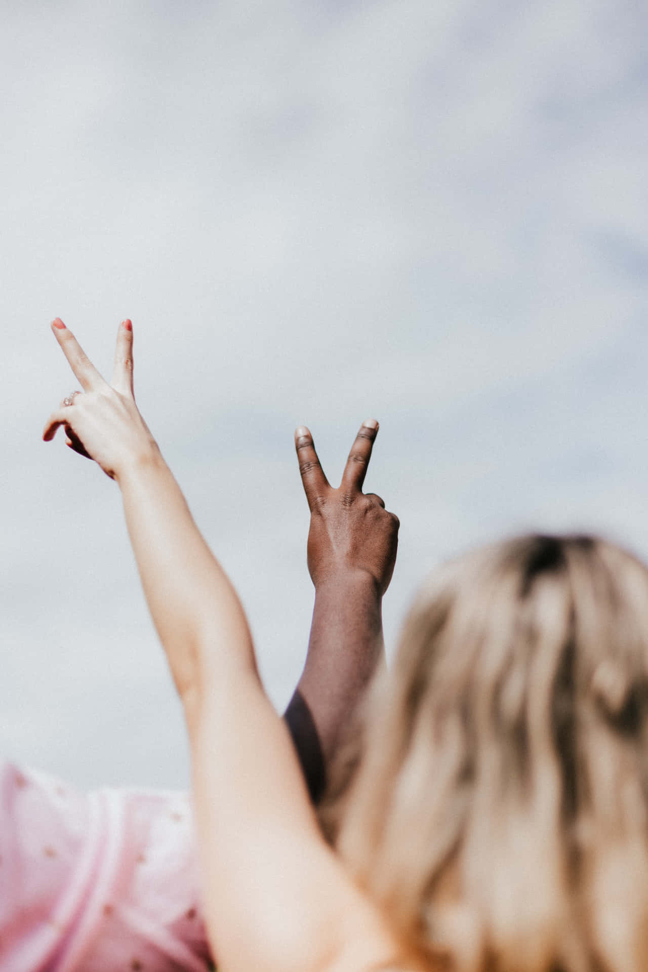 Interracial Couple Peace Sign Clear Skies Background