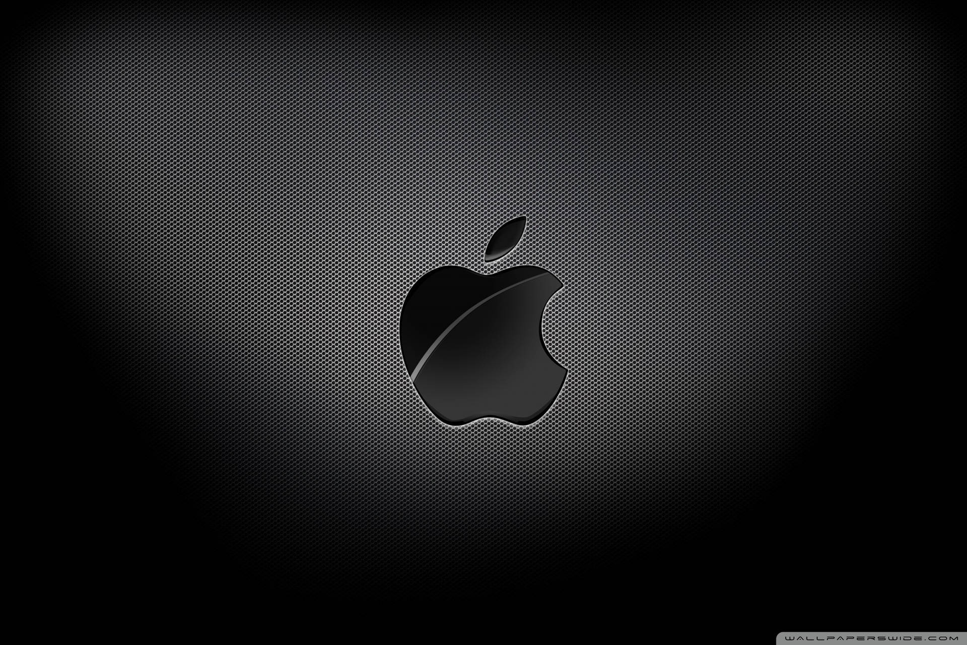 Intriguing Display Of Apple Logo In 4k Resolution On A Black Carbon Texture.