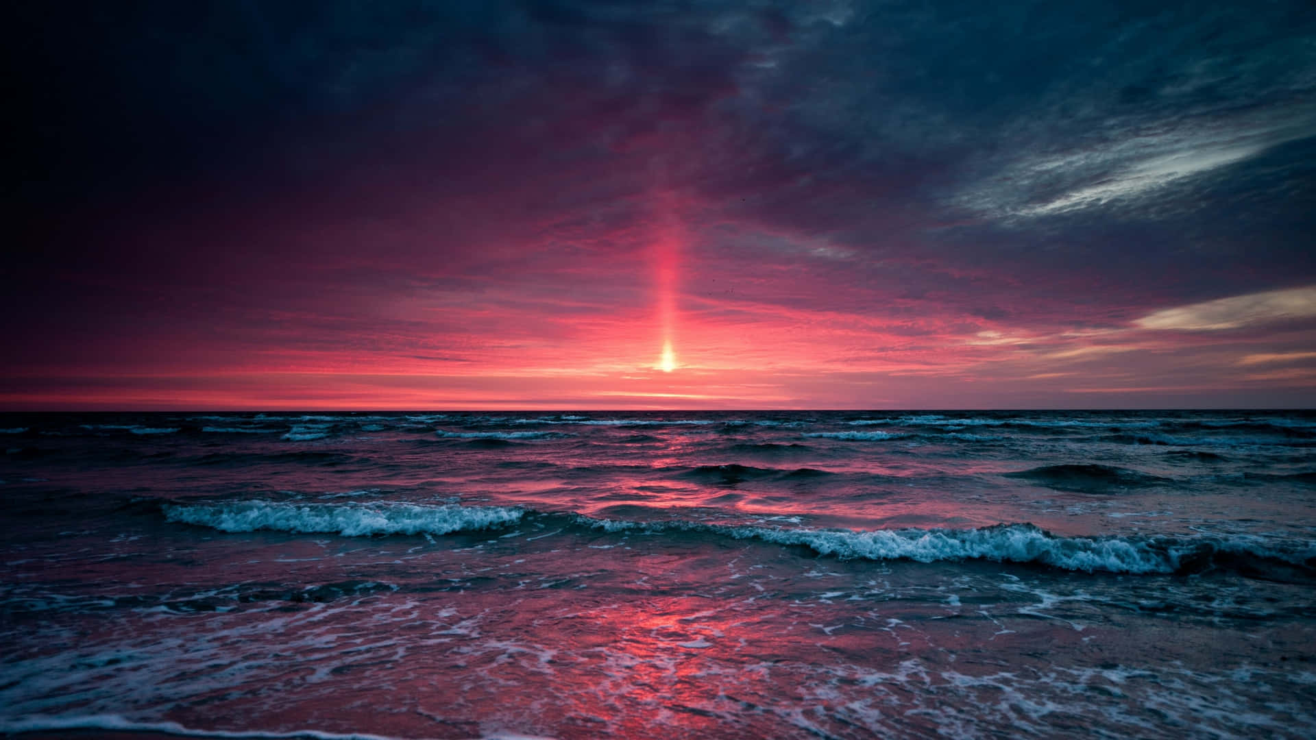 Intriguing View Of The Sunset Over Ocean Beach Background
