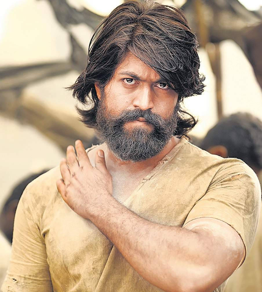 Intriguing Yash In Kgf: With His Iconic Thick Hair And Robust Beard, Capturing The Raw Essence Of His Character.