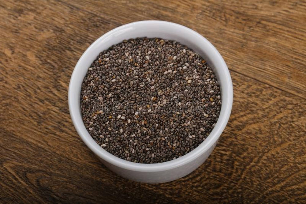 Invigorating Raw Chia Seeds In A Ramekin Bowl Background