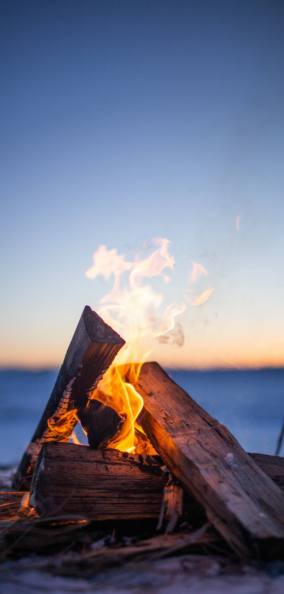 Iphone Fire Wood By The Sea Background