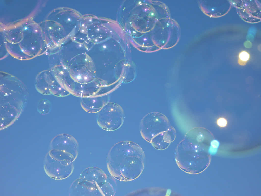 Iridescent Soap Bubbles Against Sky Background
