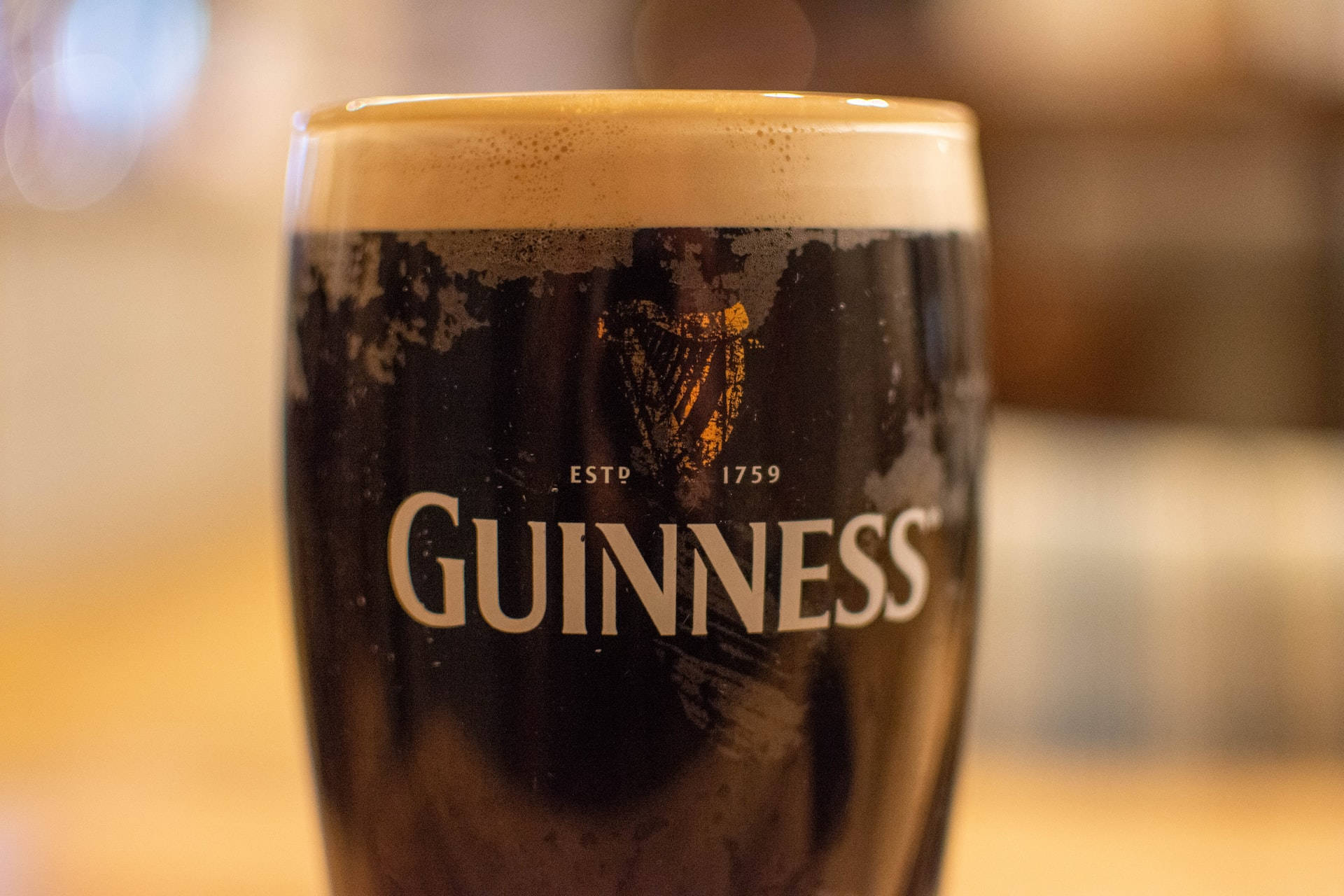 Irish Dry Stout Guinness Glass With Bubbles Background