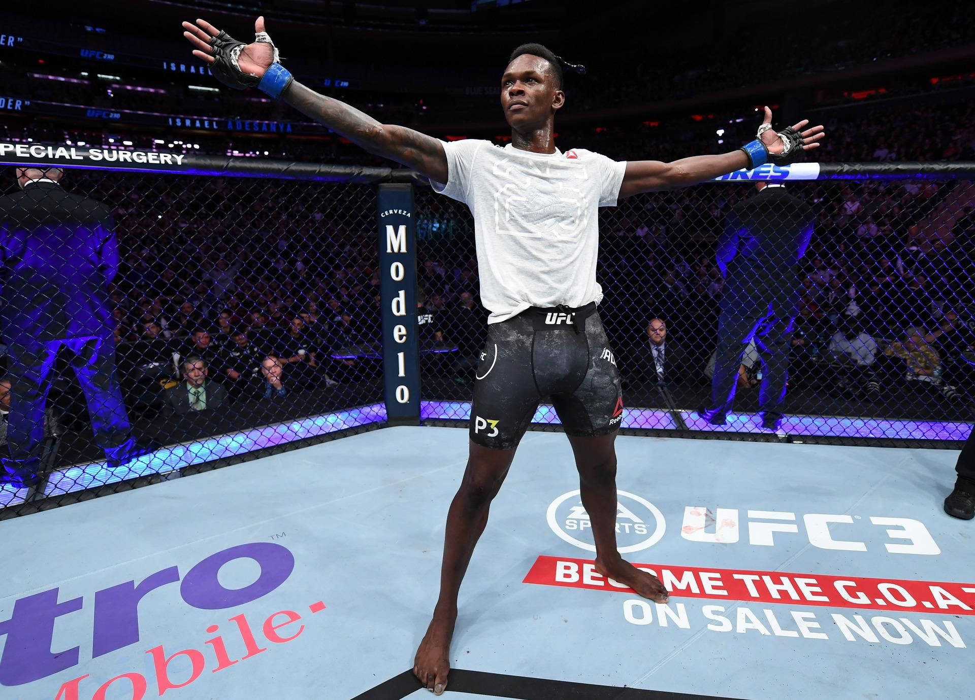 Israel Adesanya Arms Spread In Cage Background