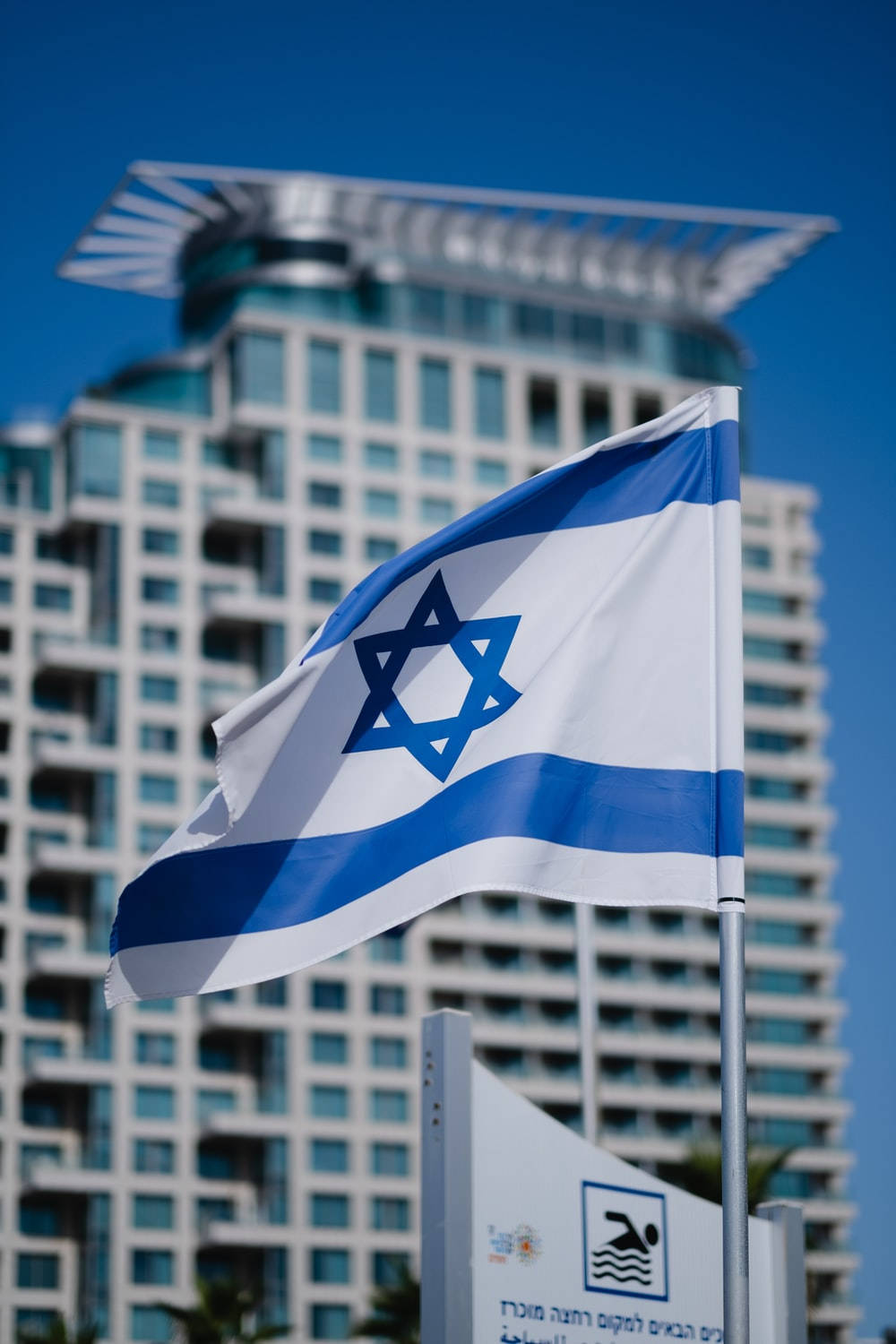 Israel Flag With Blurry Building Background