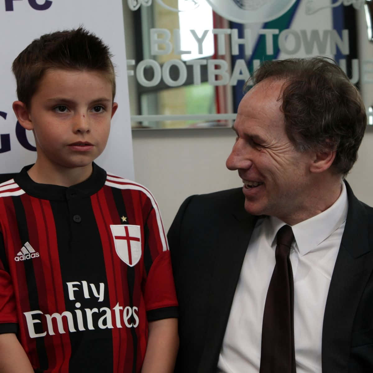 Italian Football Legend Franco Baresi Posing With A Young Fan Background