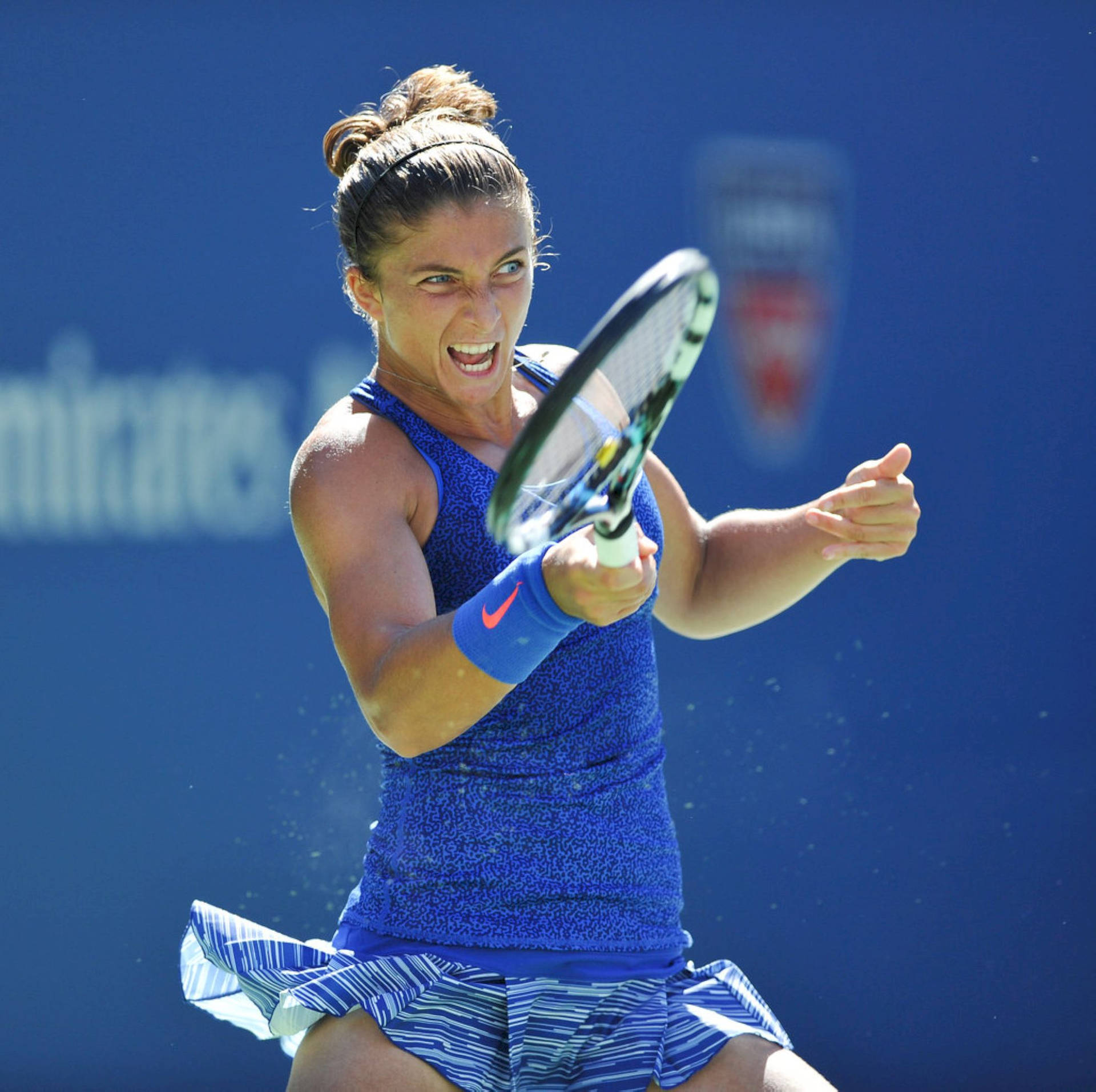 Italian Professional Tennis Player Sara Errani Showcasing A Committed Expression During A Match. Background