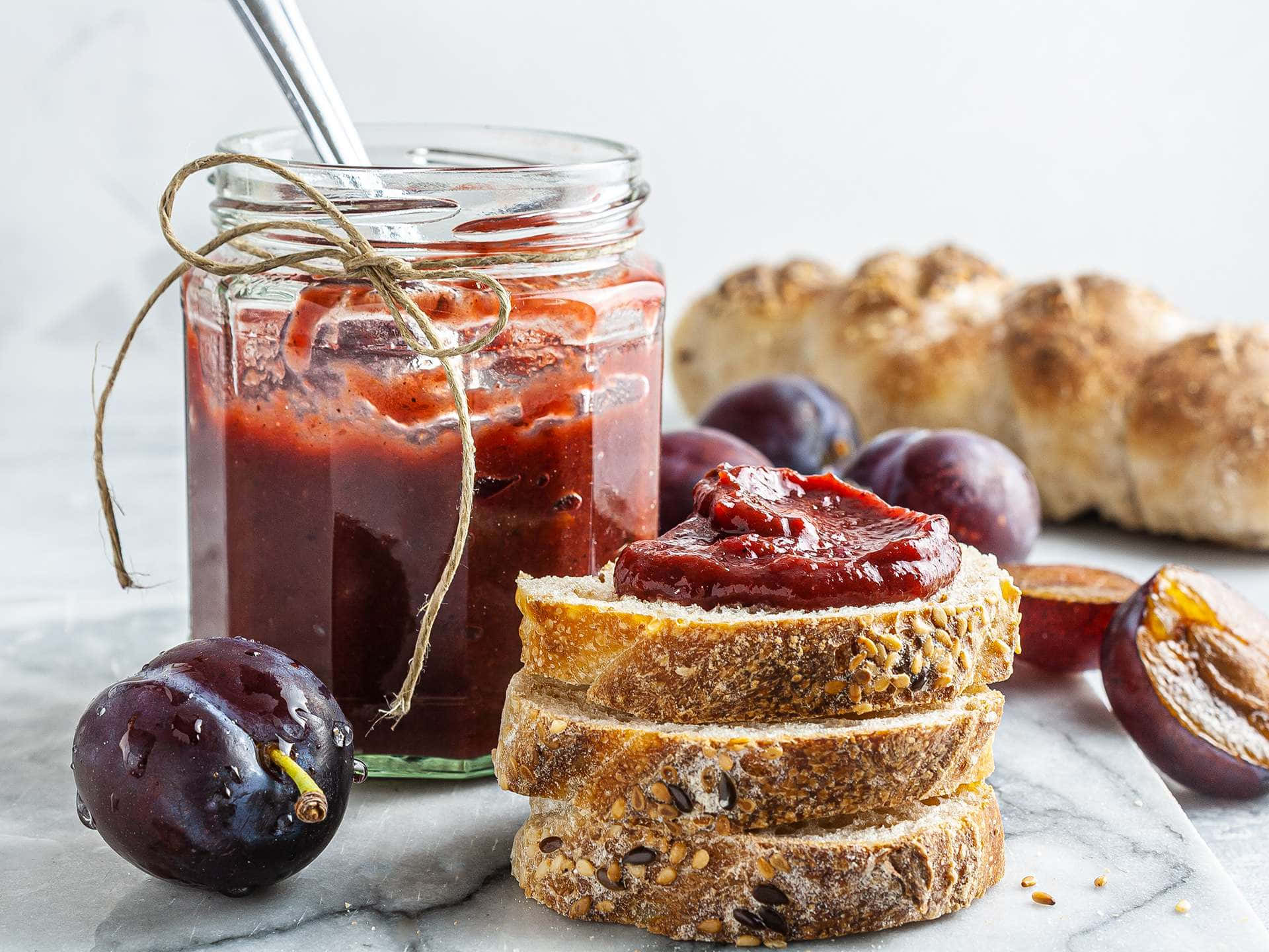Italian Prune Plum Red Jam With Bread Background